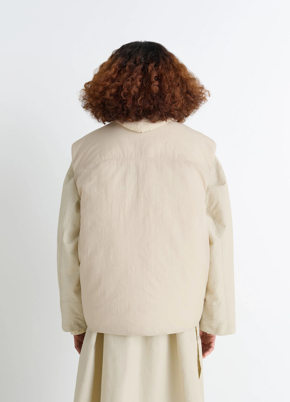 Lemaire Wadded Gilet with Pockets in Beige Water-Repellent Nylon, model shot, back view rear shoulder seam detail