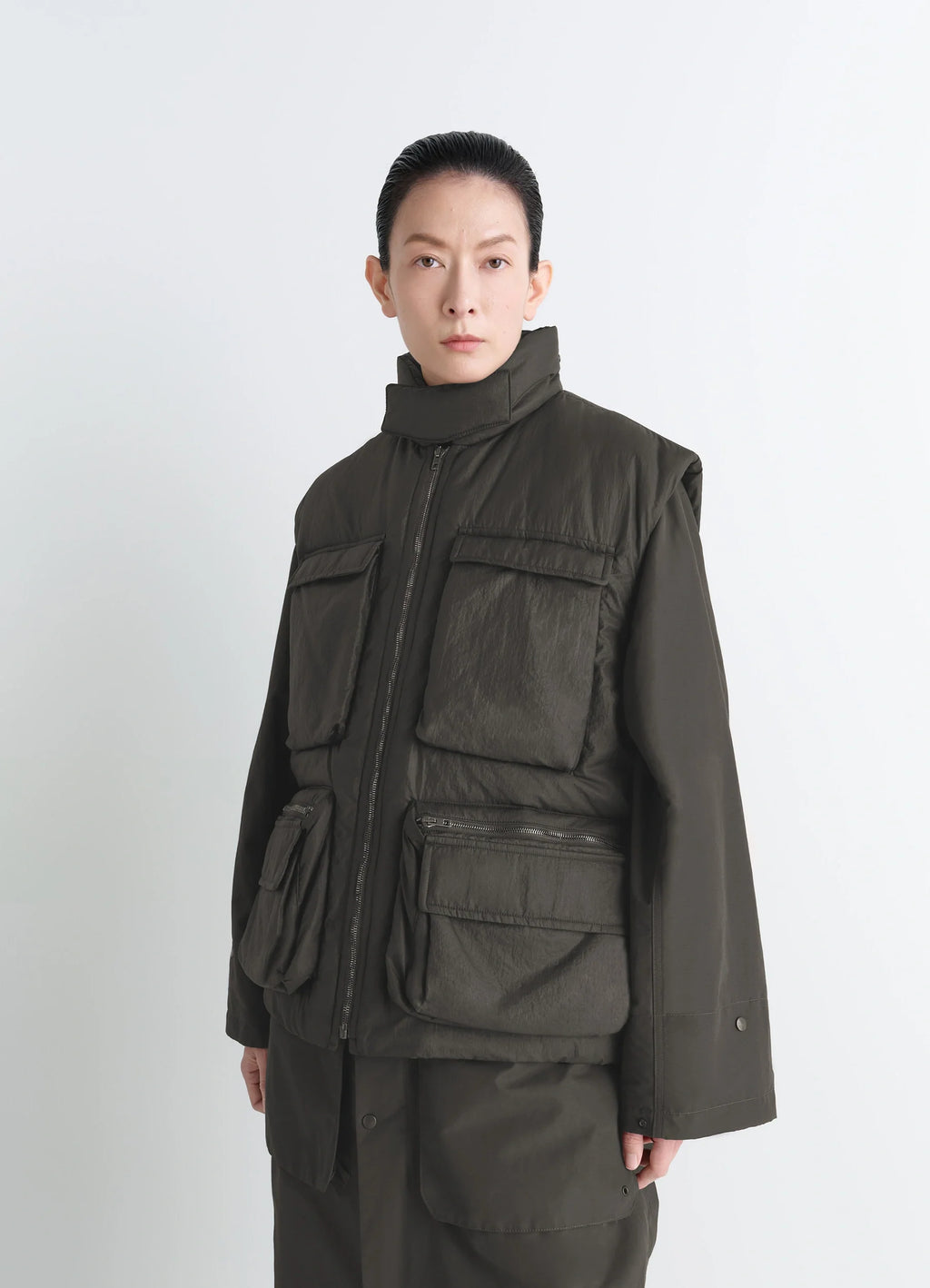 Lemaire Wadded Gilet in Deep Brown Nylon, model shot, Front side view Gusseted pockets