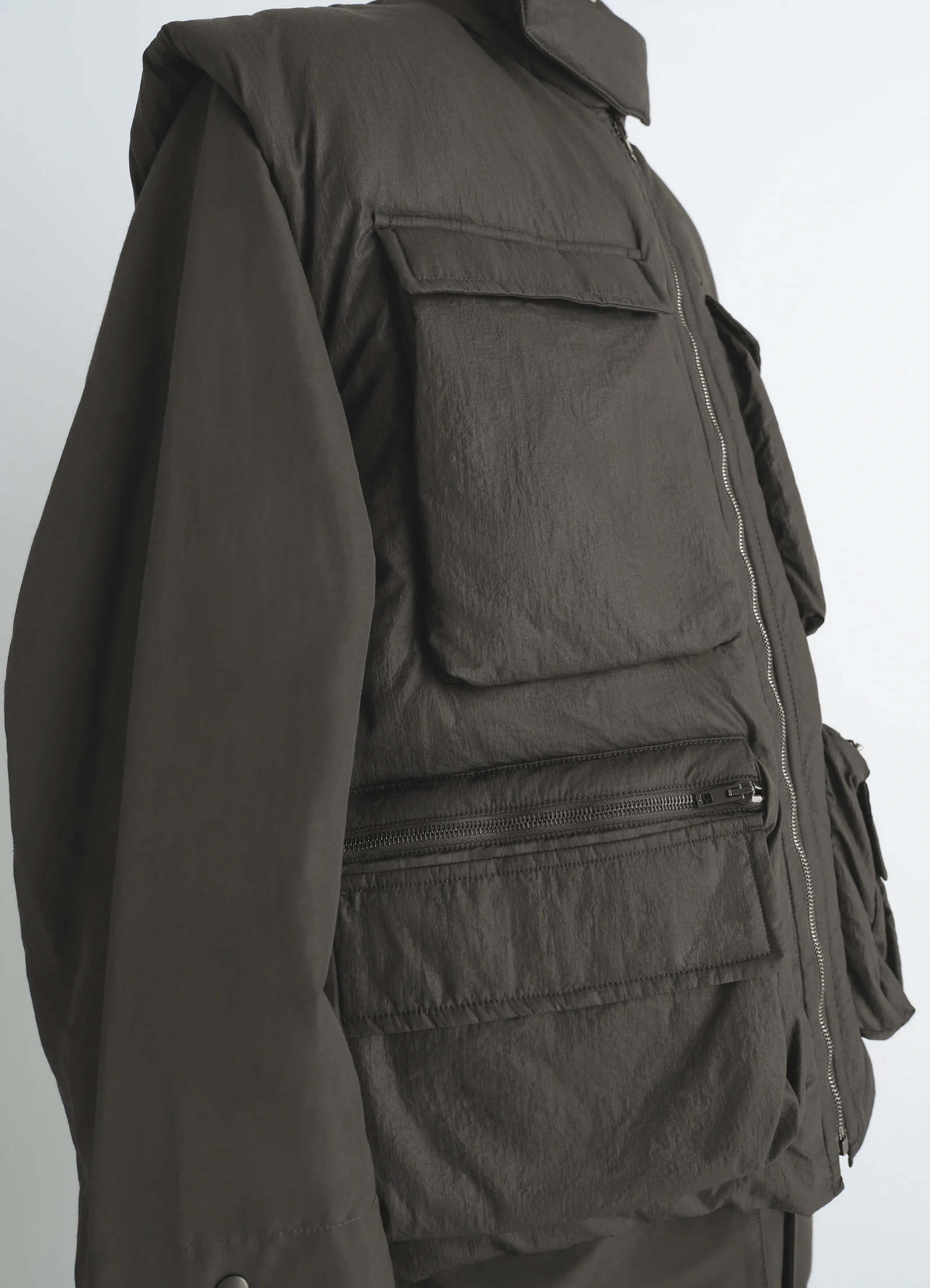 Lemaire wadded gilet in deep brown nylon, model shot, back side view zipper detail