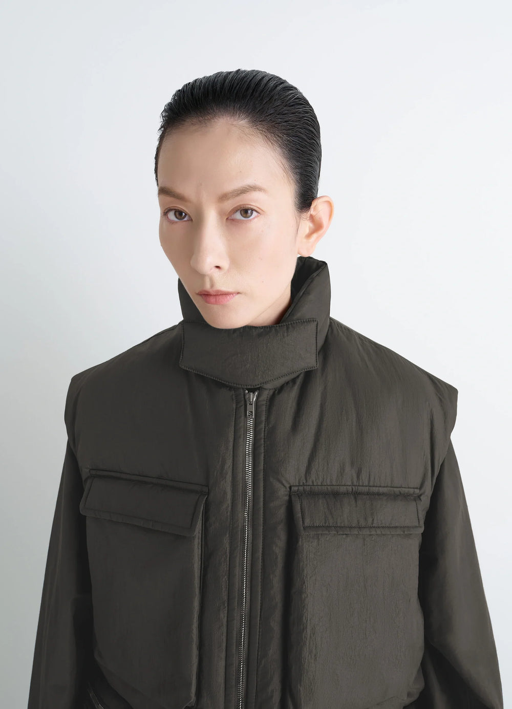 Lemaire Wadded Gilet in Deep Brown Nylon, model shot, close-up front view high collar detail