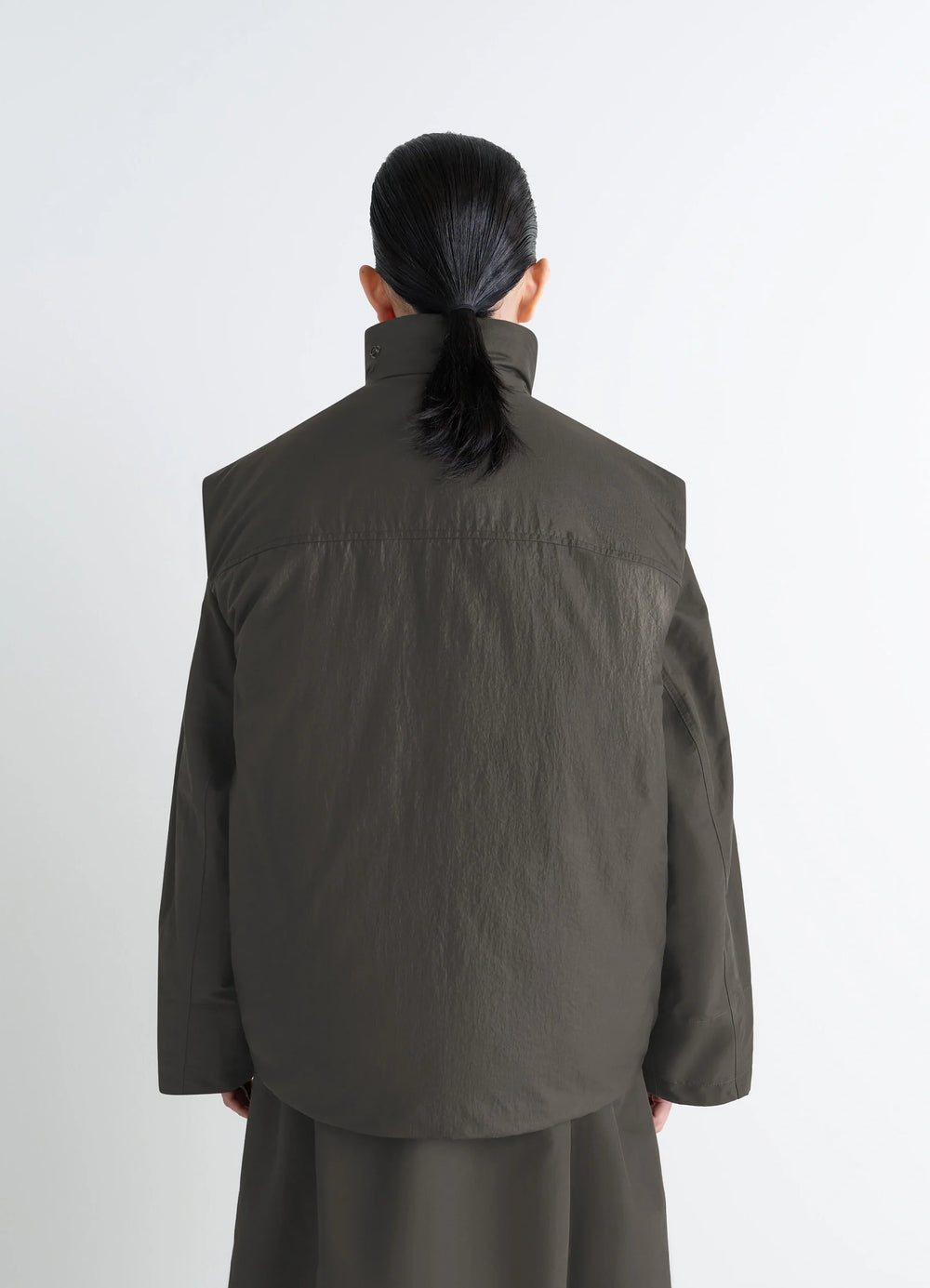 Lemaire Wadded Gilet in Deep Brown Nylon, model shot, back straight view high collar worn