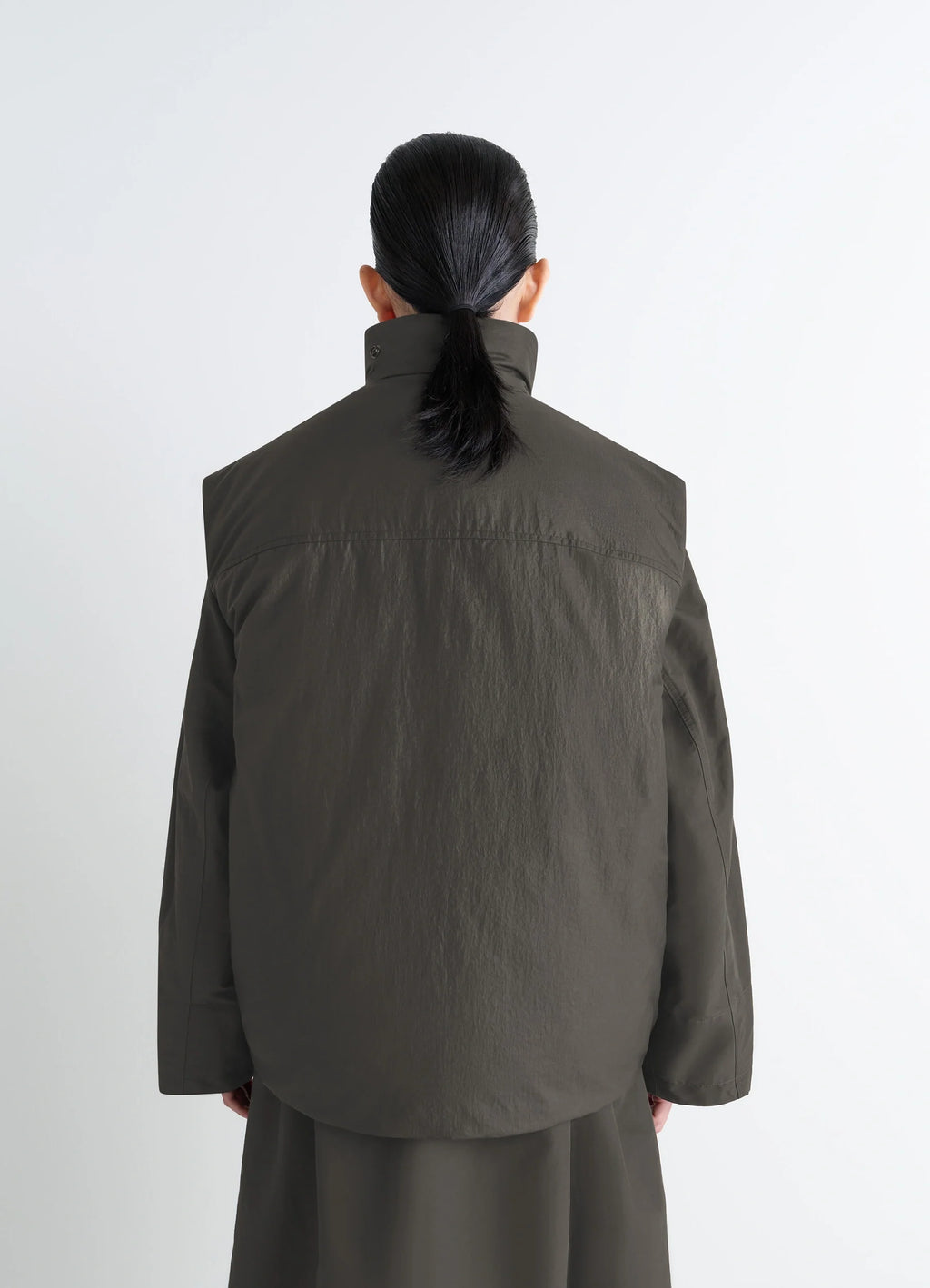Lemaire Wadded Gilet in Deep Brown Nylon, model shot, back straight view high collar worn