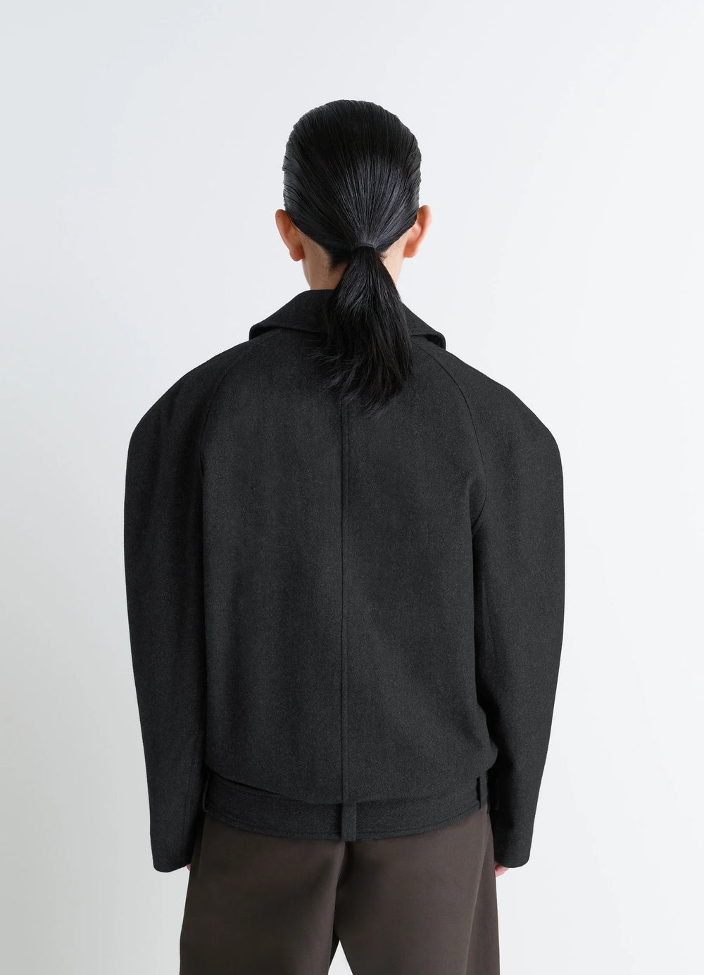 Lemaire Raglan Sleeve Short Coat in RWS wool and cotton twill, model shot, back view tailored shoulder line