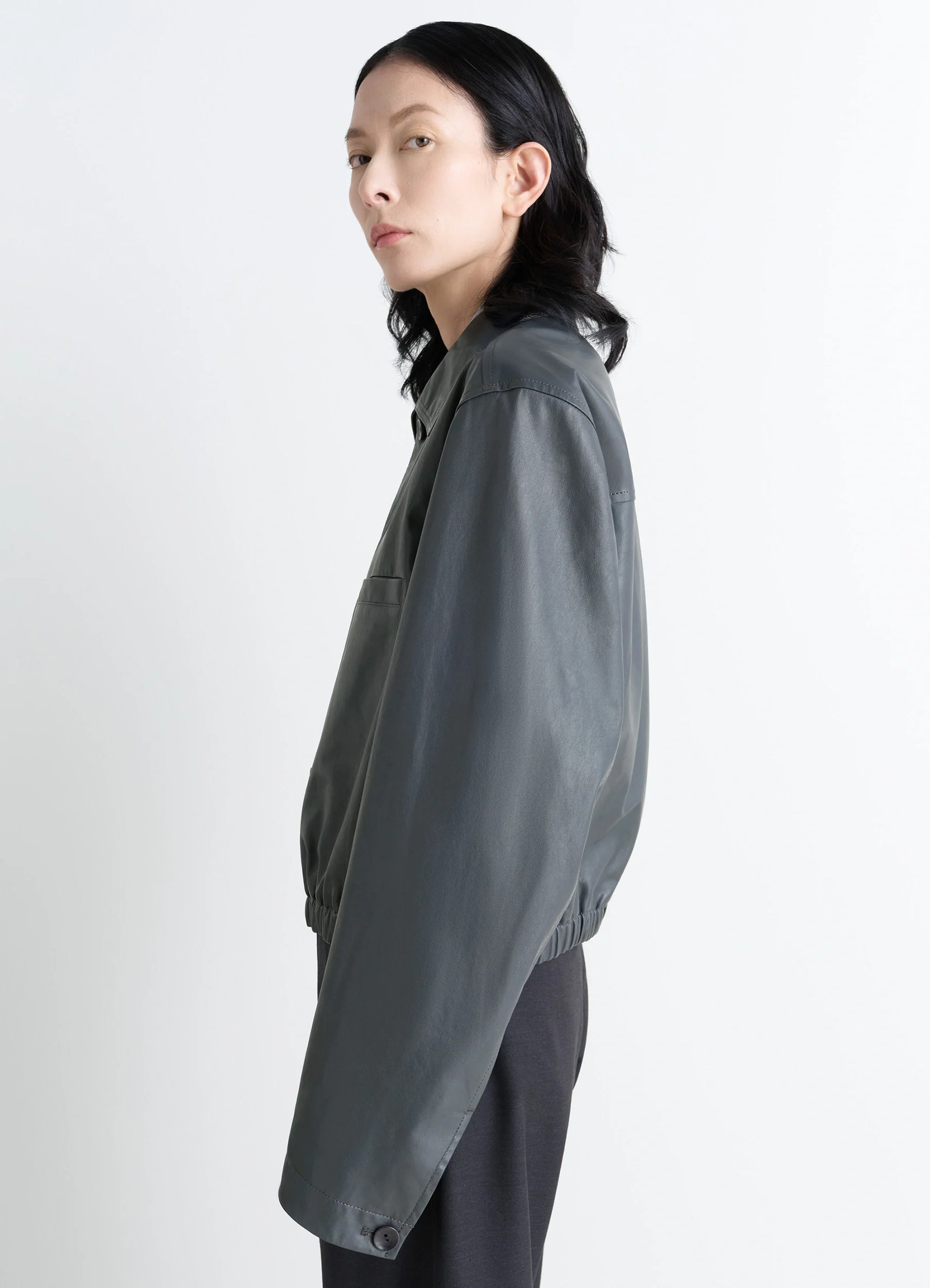 Lemaire soft leather blouson in soft cow leather, model shot, side profile long sleeves, elasticated hem