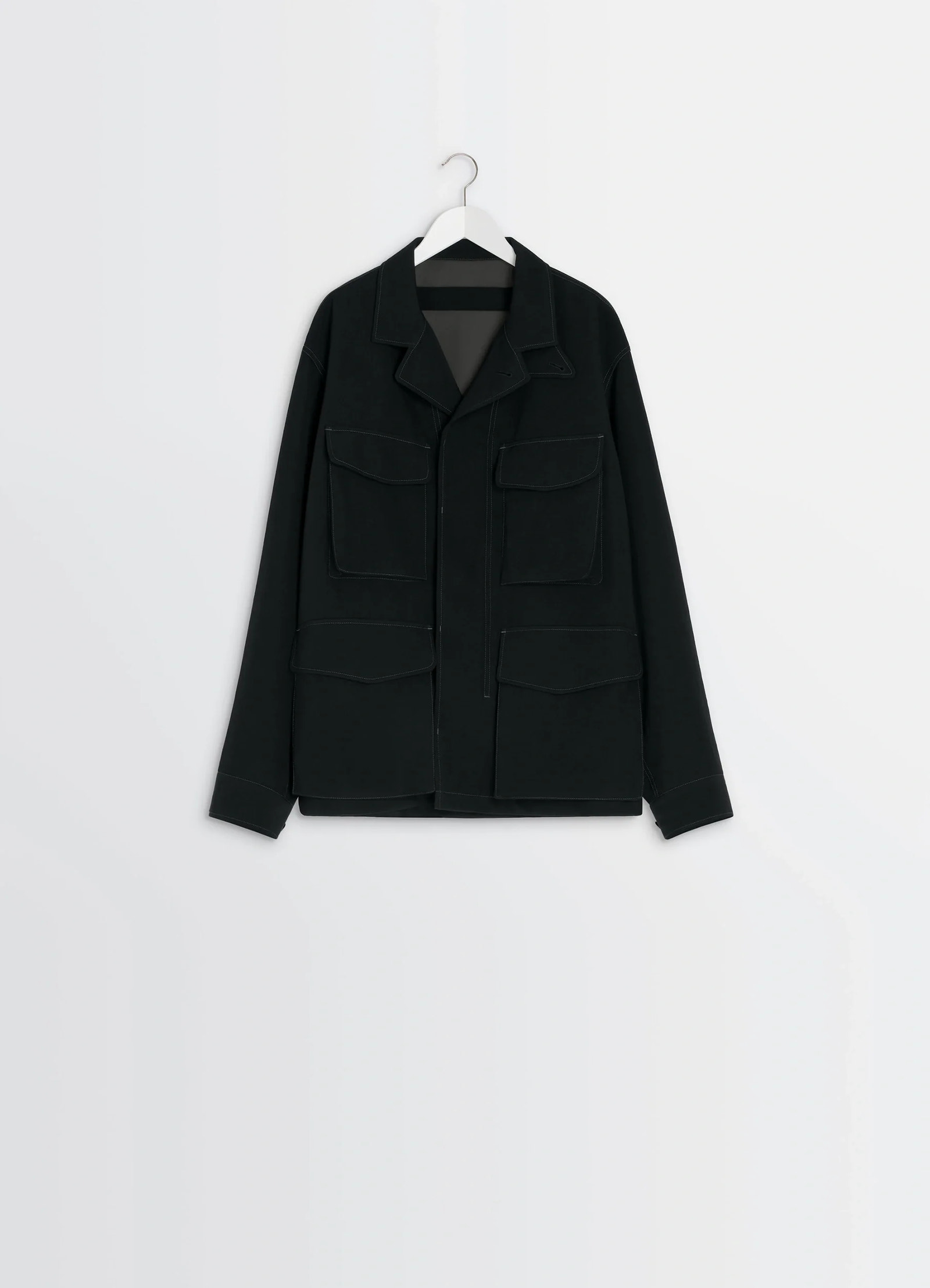 Soft field jacket in black wool twill, product shot, hanging display shot layered front pockets