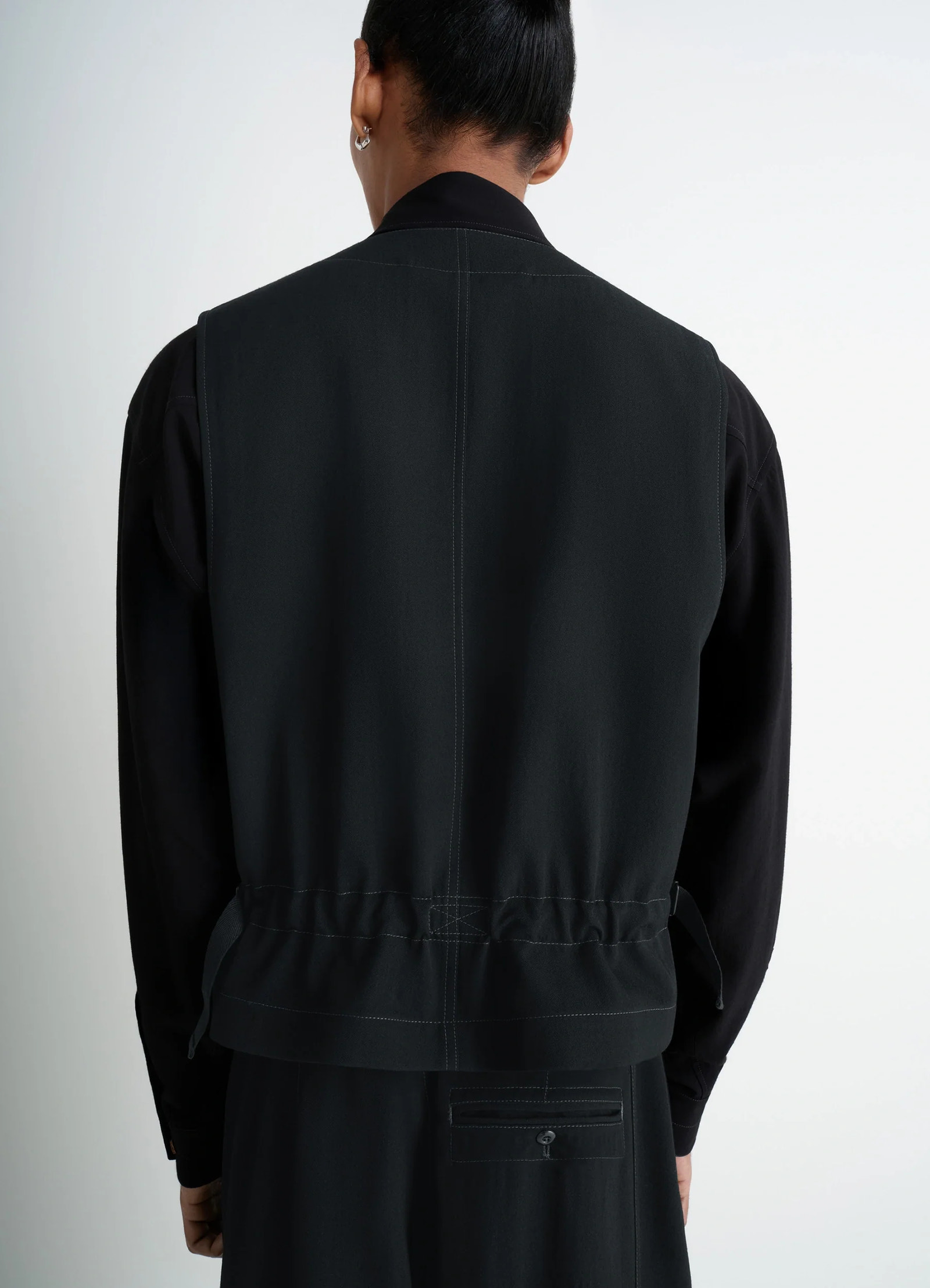 Utility gilet in light wool twill, model shot, back view seam detailing
