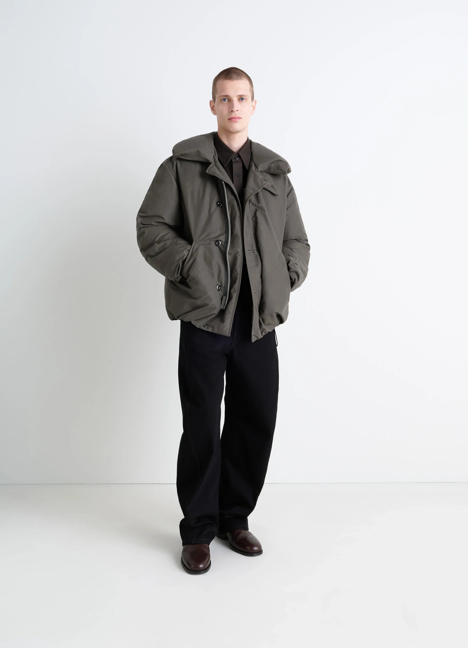 Puffer blouson in olive linen cotton, model shot, three-quarter view feather-filled design