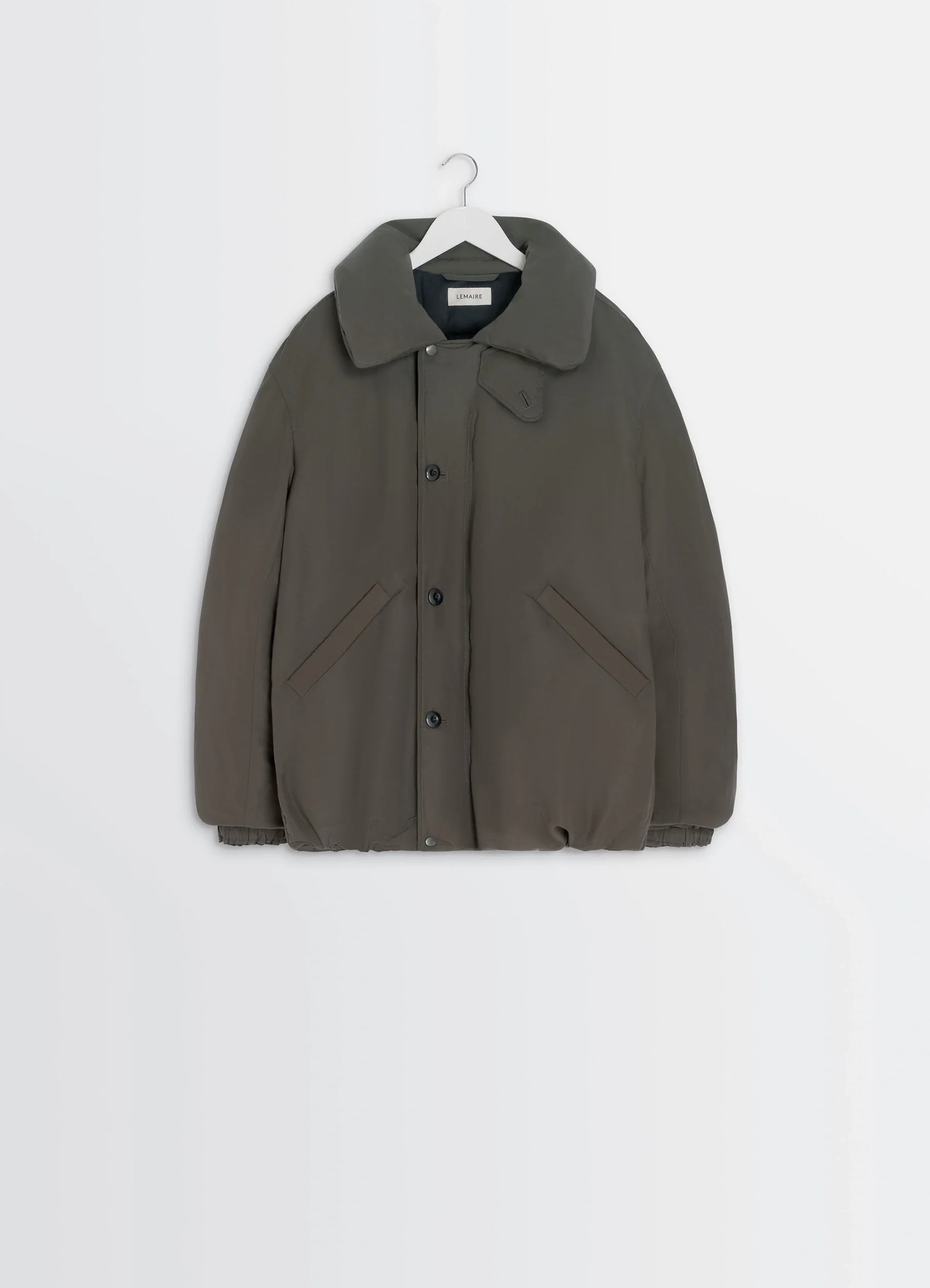 Puffer blouson in olive linen cotton, product shot, hanging display buttoned front pockets