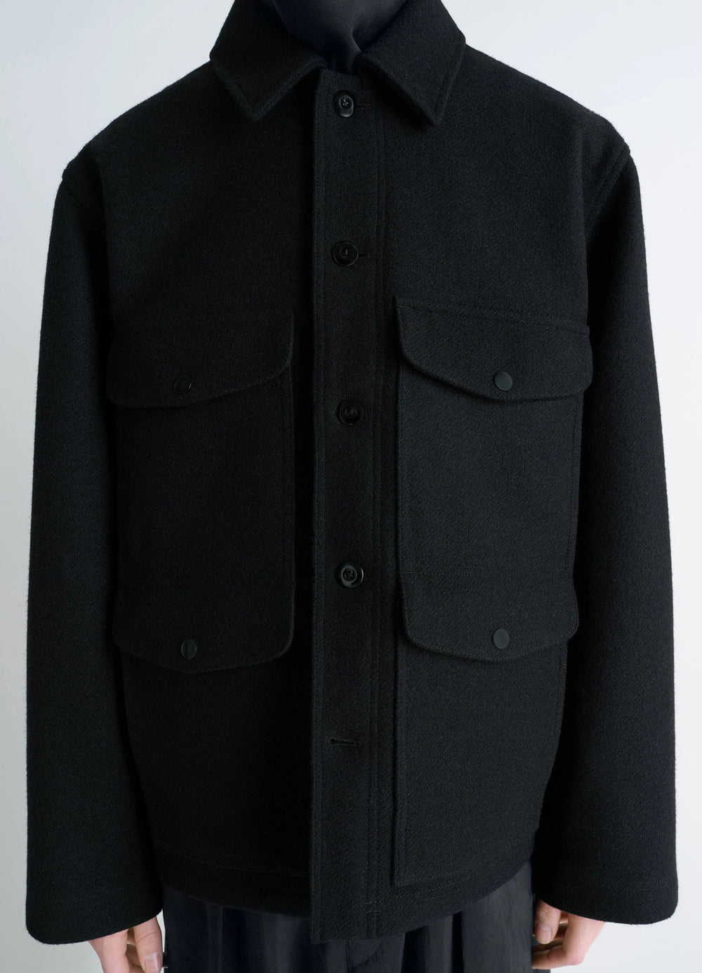 Lemaire Utility Jacket in Black Melton Wool, model shot, close-up front view buttoned pockets visible