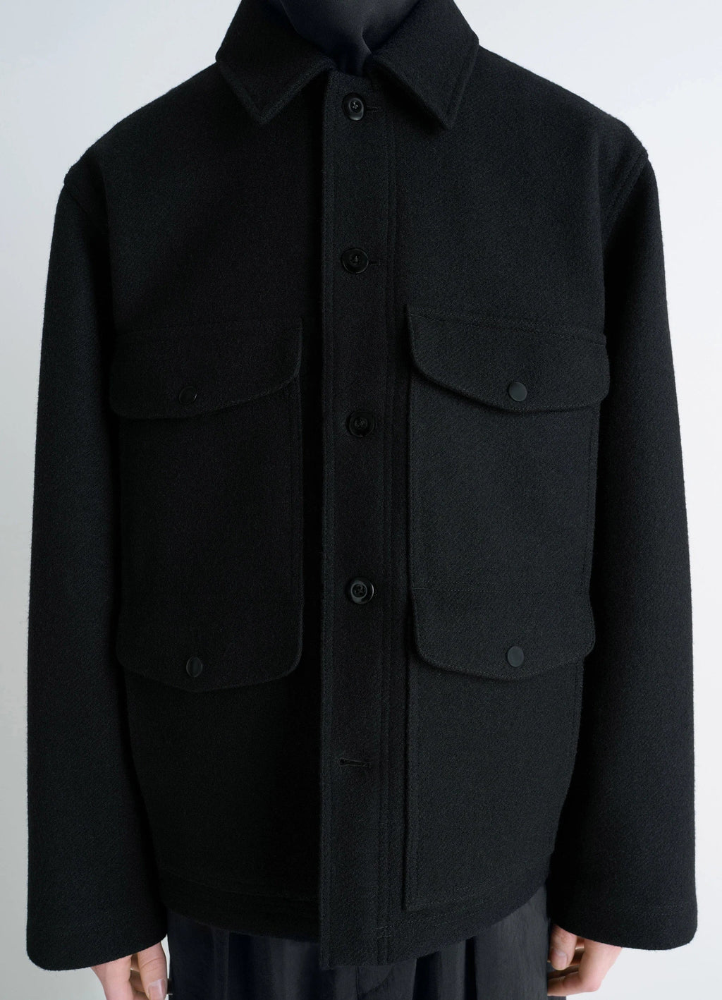 Lemaire Utility Jacket in Black Melton Wool, model shot, close-up front view buttoned pockets visible