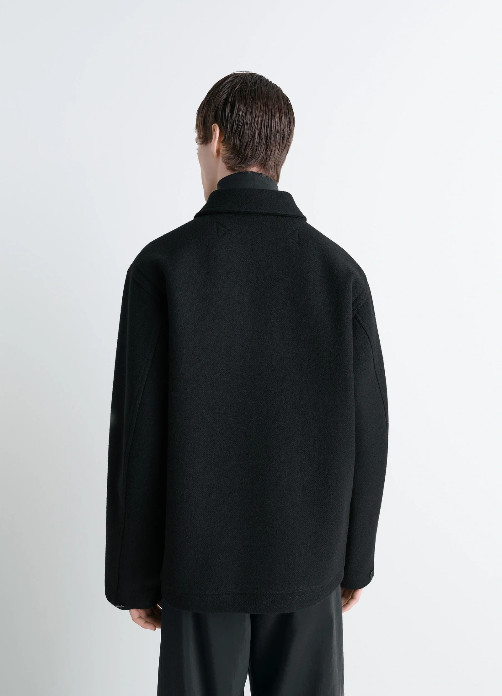 Lemaire utility jacket in black melton wool, model shot, back view straight hem, dropped shoulders