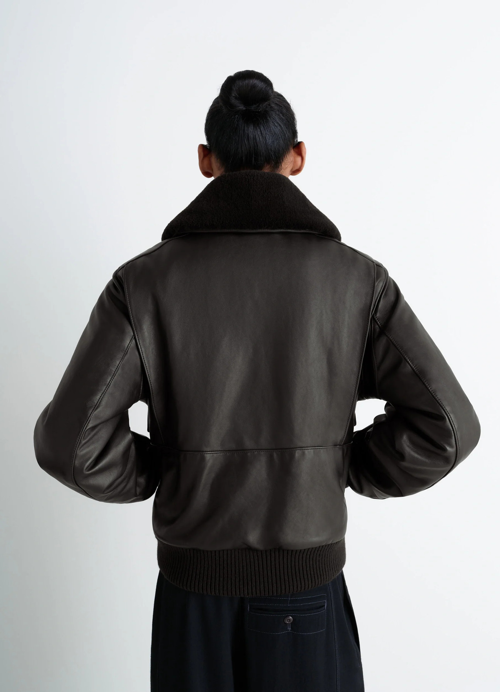 Lemaire leather blouson in brown cow leather, model shot, back view ribbed hem