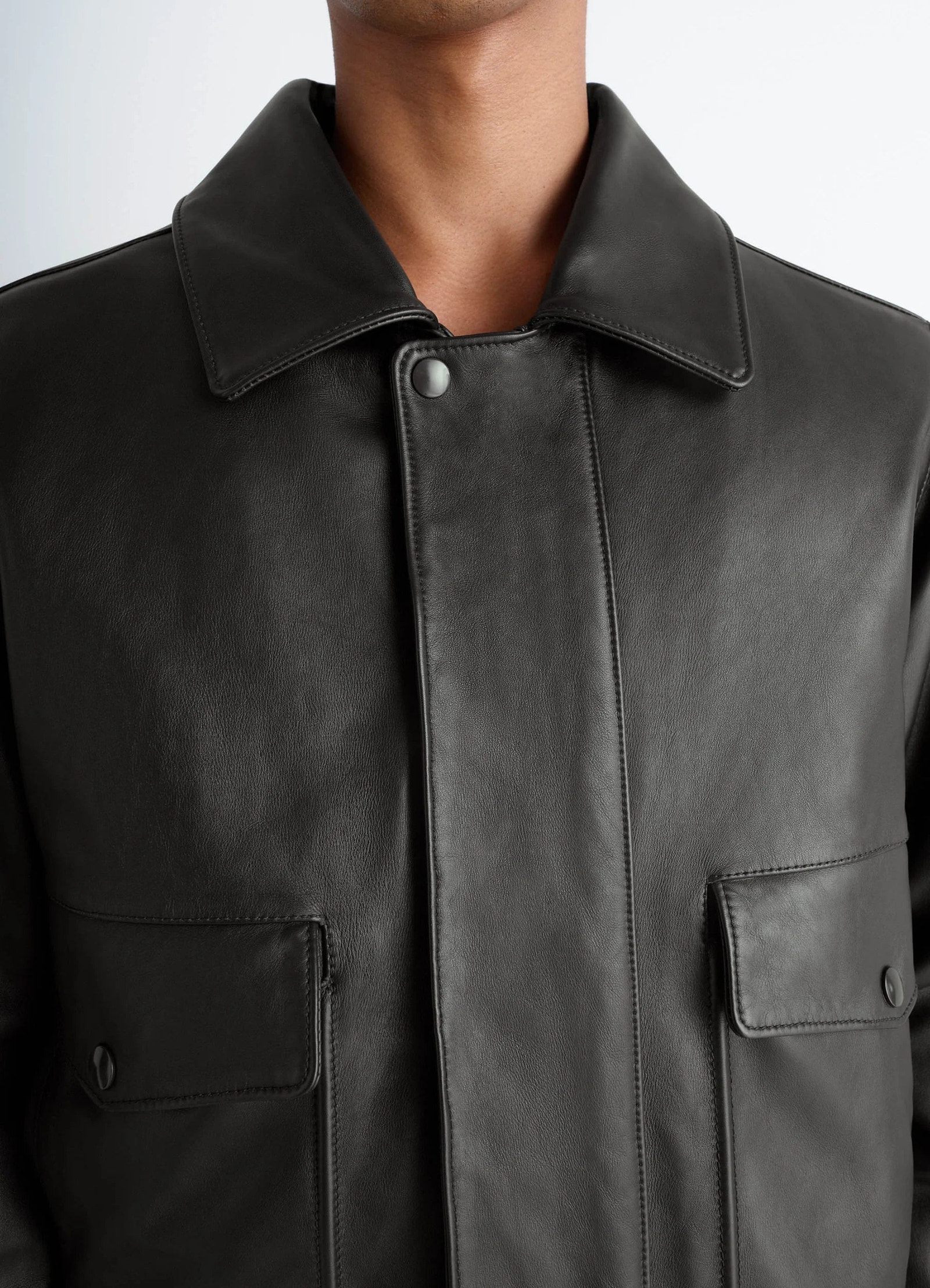 Lemaire leather blouson in brown cow leather, model shot, close-up detail view buttoned placket, pointed collar