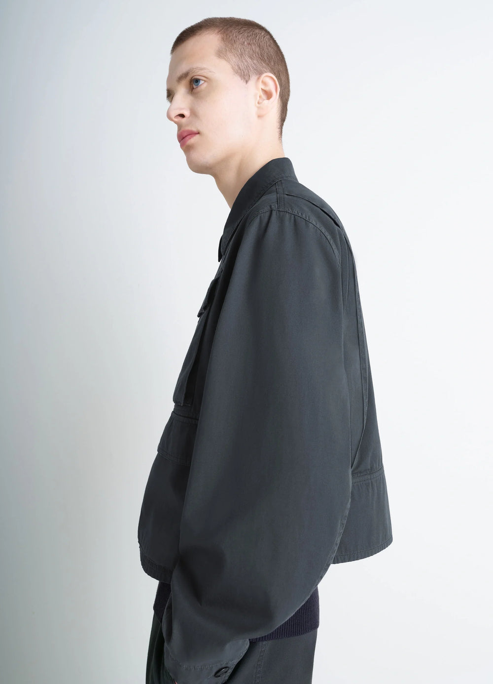 Short Utility Jacket in Dark Cotton Twill, model shot, side profile view straight sleeve cut