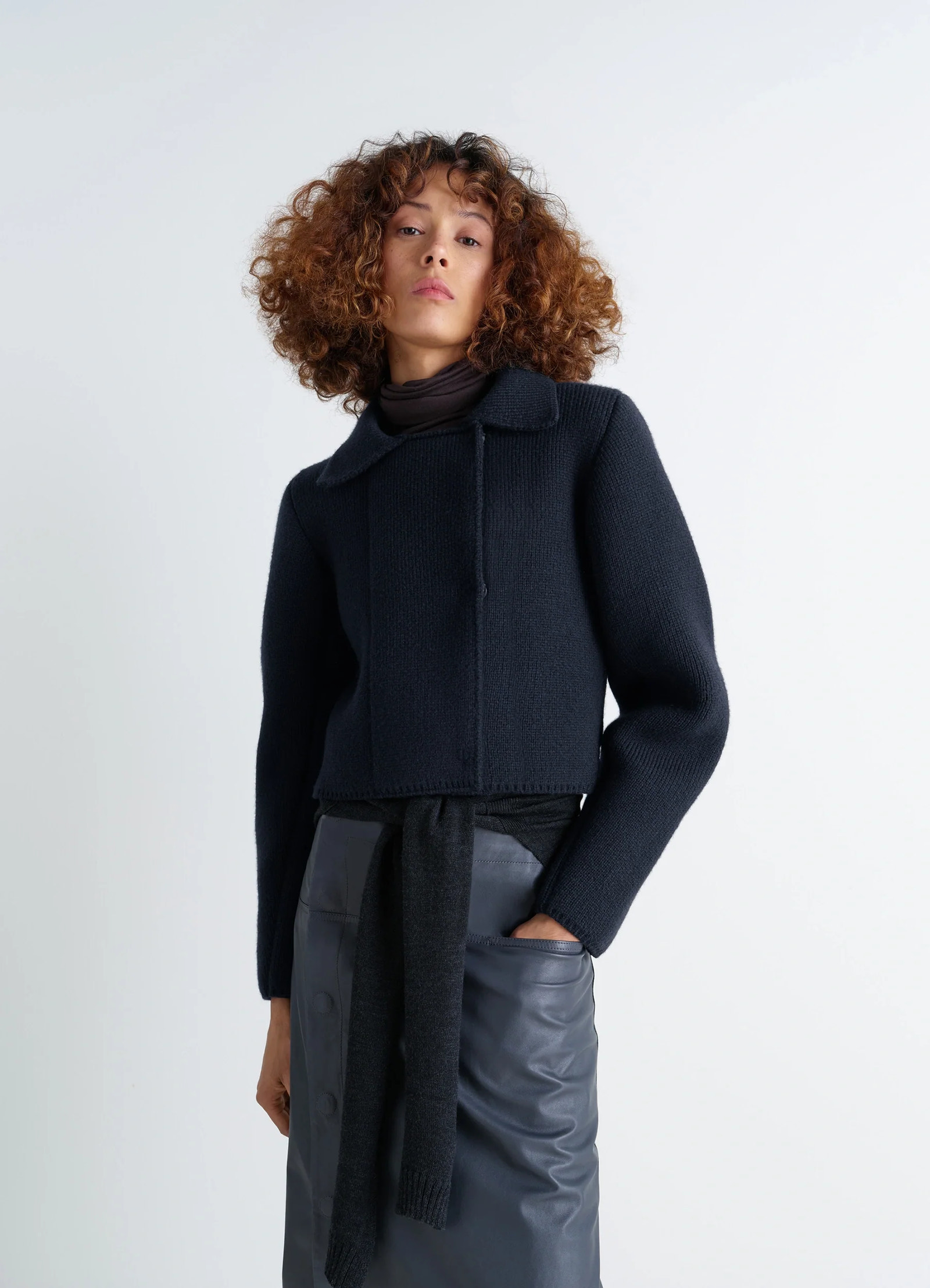 Felted blouson in navy wool blend, model shot, front side view architectural silhouette