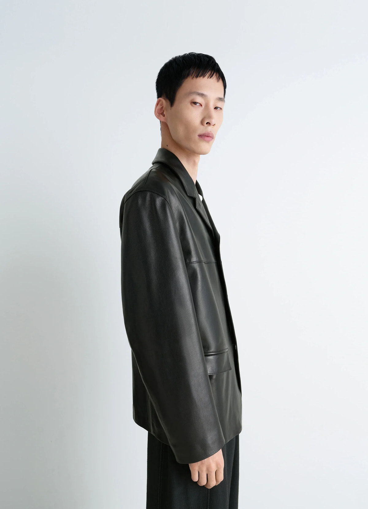 Leather single breasted jacket in nappa lamb leather, model shot, side view sleek silhouette