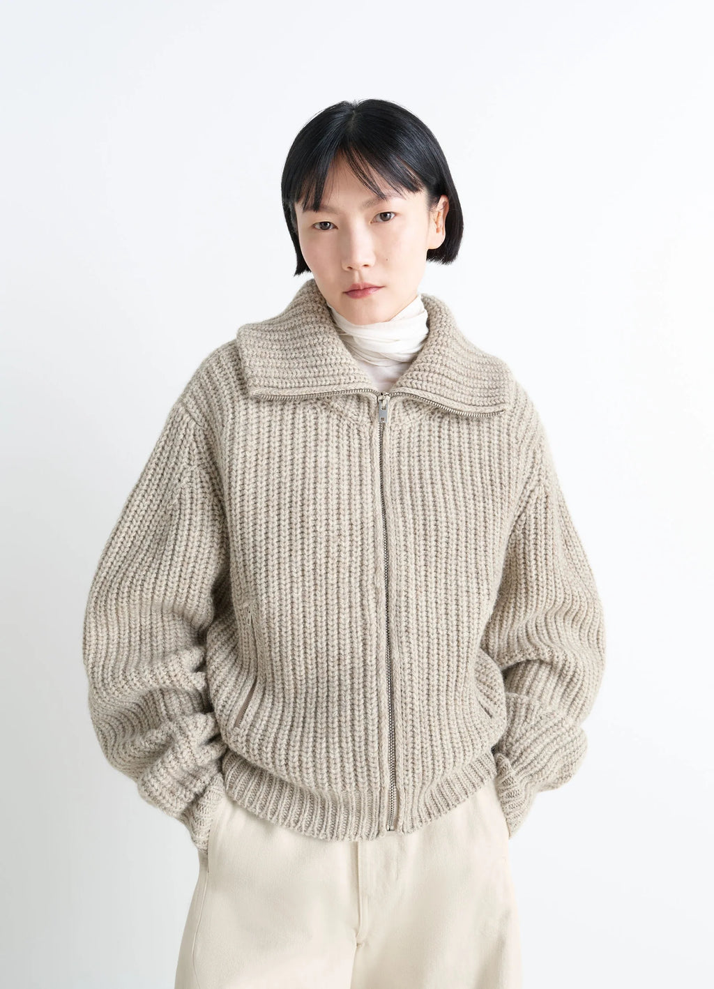 zip-up cardigan with stand-up colla in alpaca and yak wool knit, model shot, front view densely ribbed, textured look