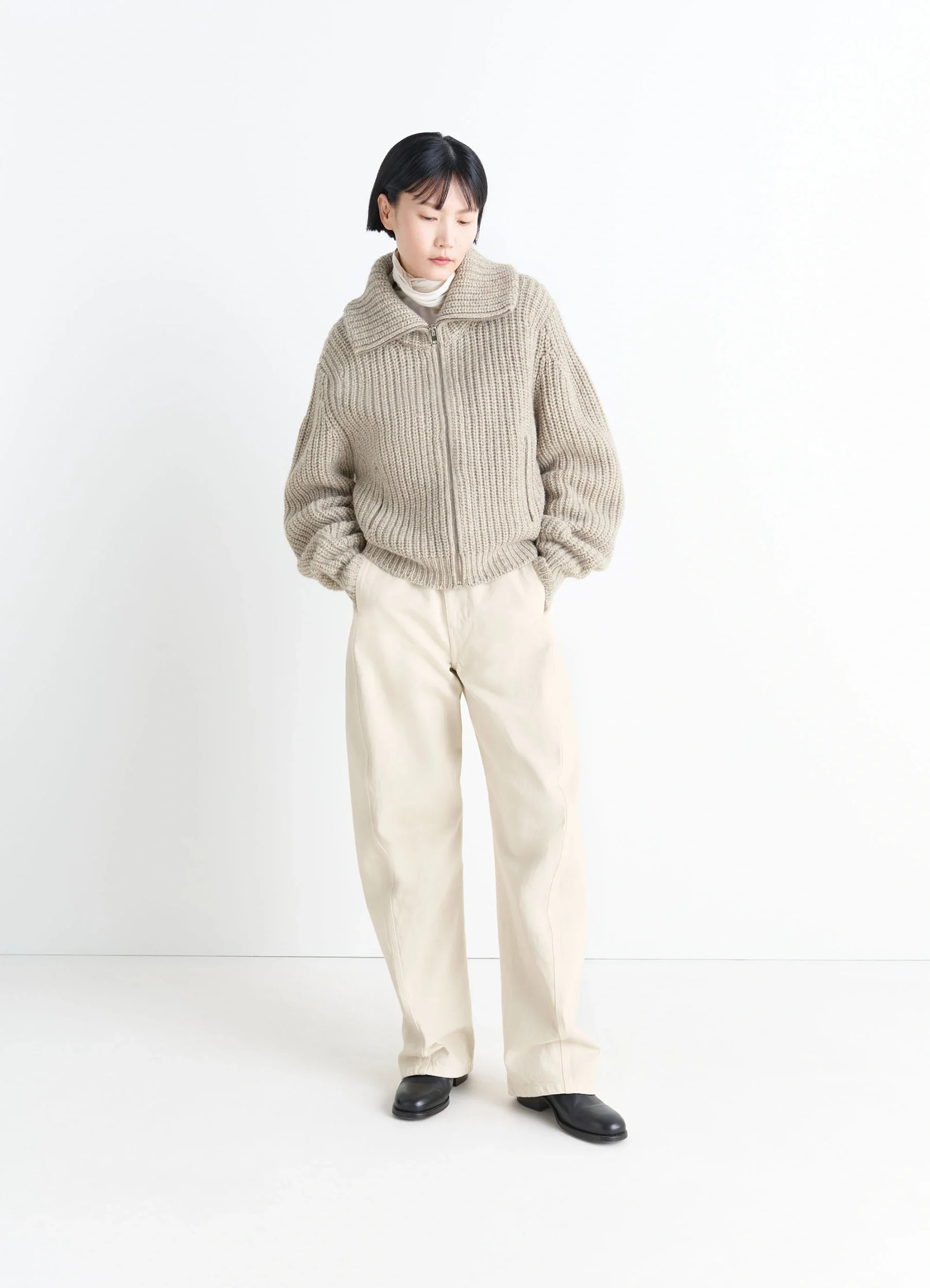 Zip-up cardigan with stand-up colla in alpaca and yak wool knit, model shot, three-quarter view relaxed fit, drop shoulders