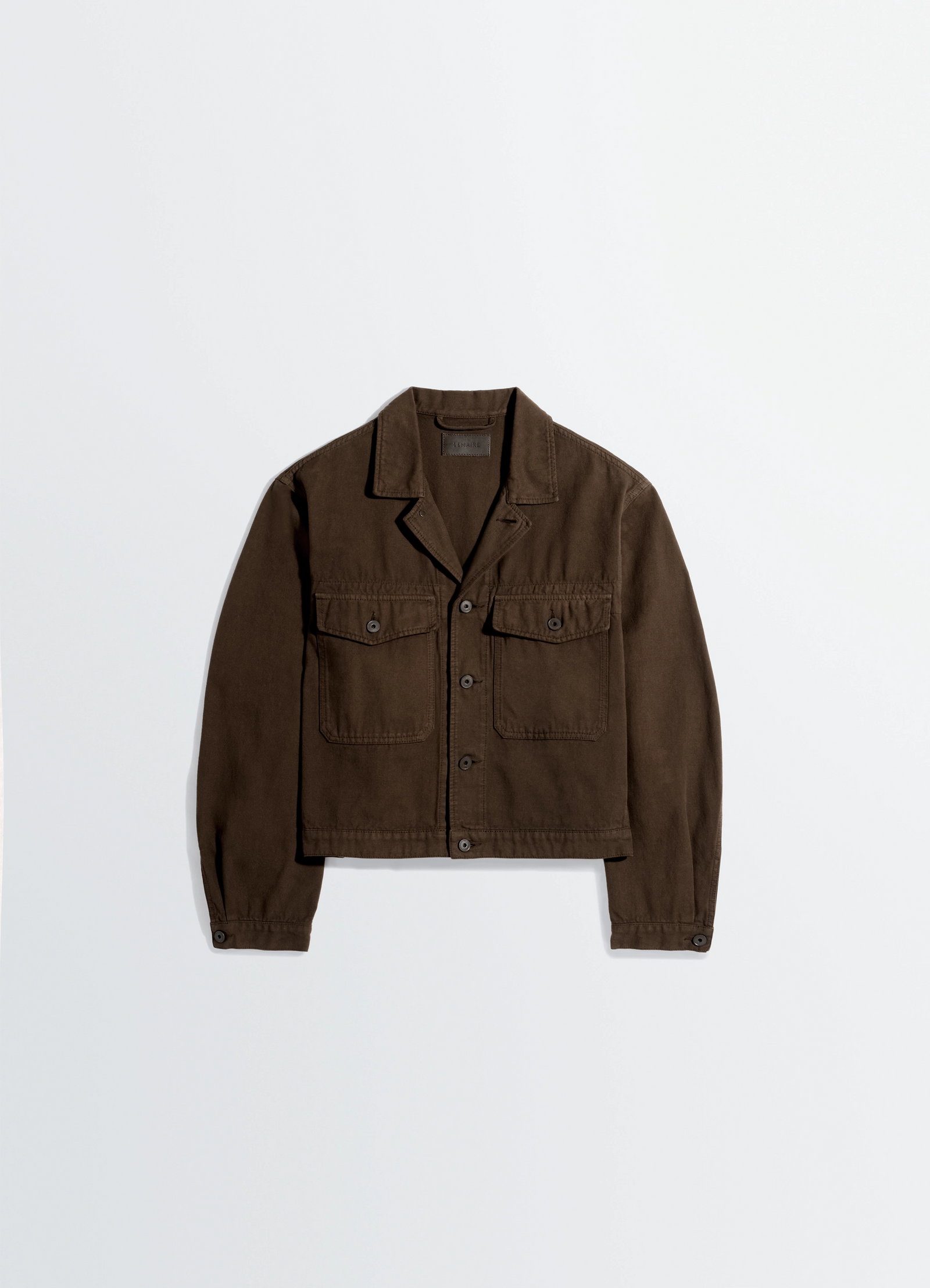 Trucker jacket in dyed broken twill in dyed broken twill, product shot, top-down view straight hem, buttoned cuffs
