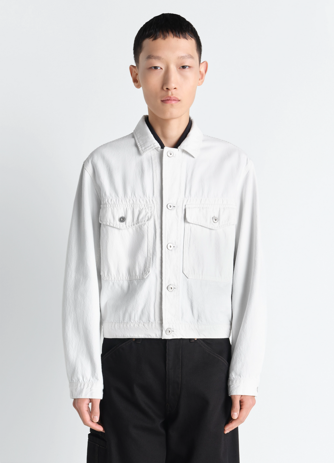 Trucker Jacket in Denim in Thick Bleached Denim, model shot, Front view Fitted cut