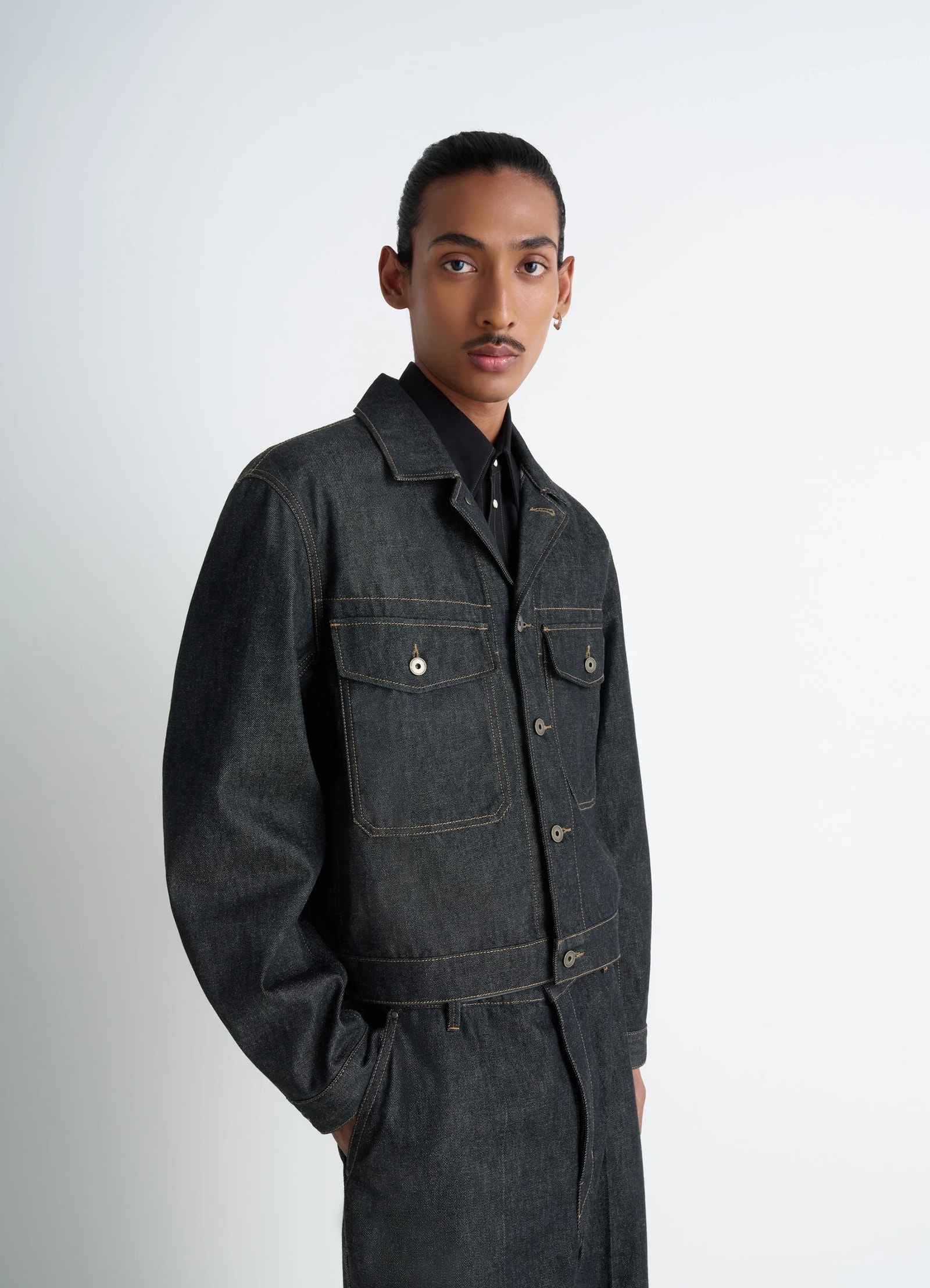 Lemaire trucker jacket in slate denim, model shot, shoulder view relaxed shoulder cut