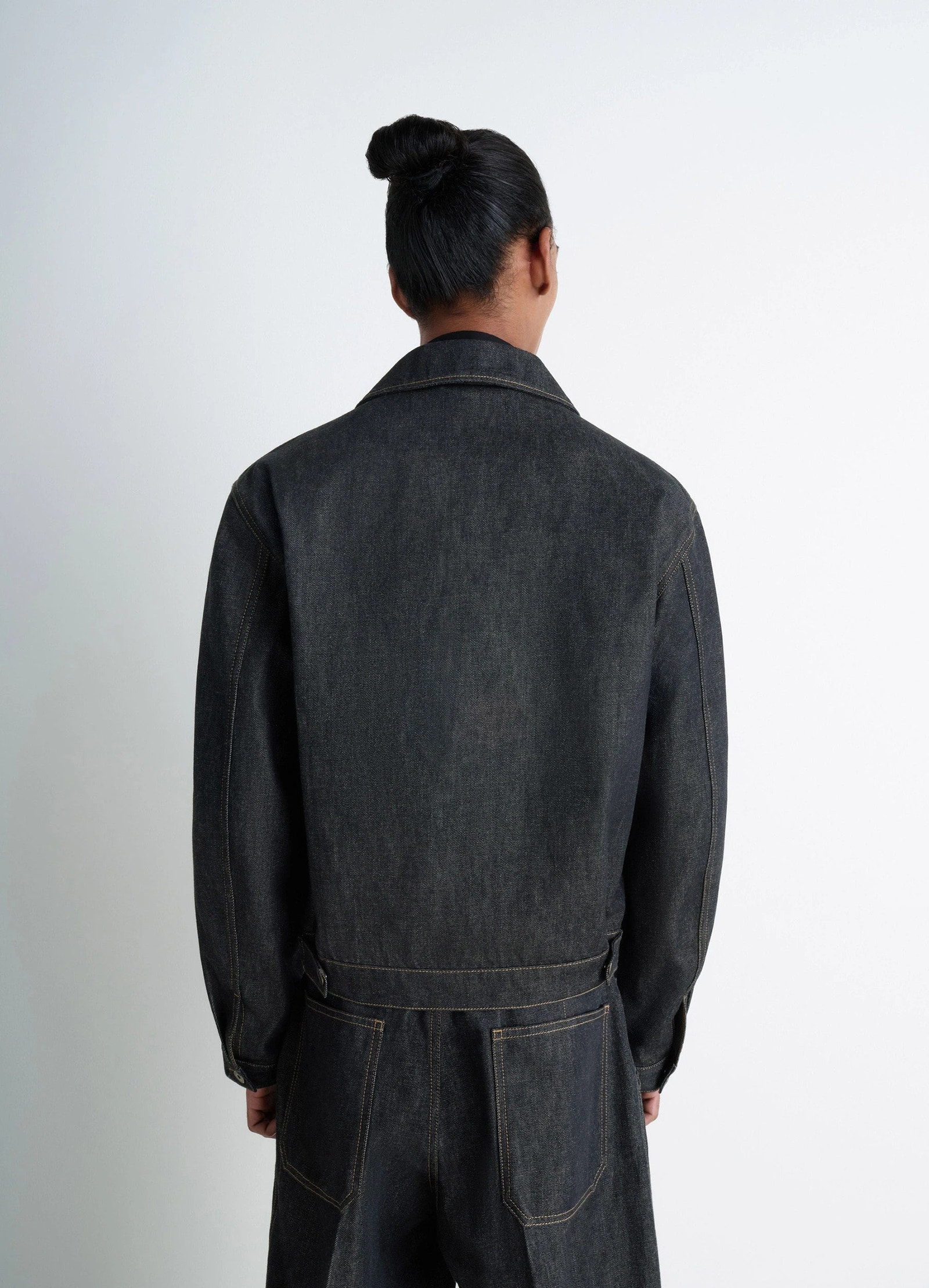 Lemaire trucker jacket in slate denim, model shot, back view adjustable waistband