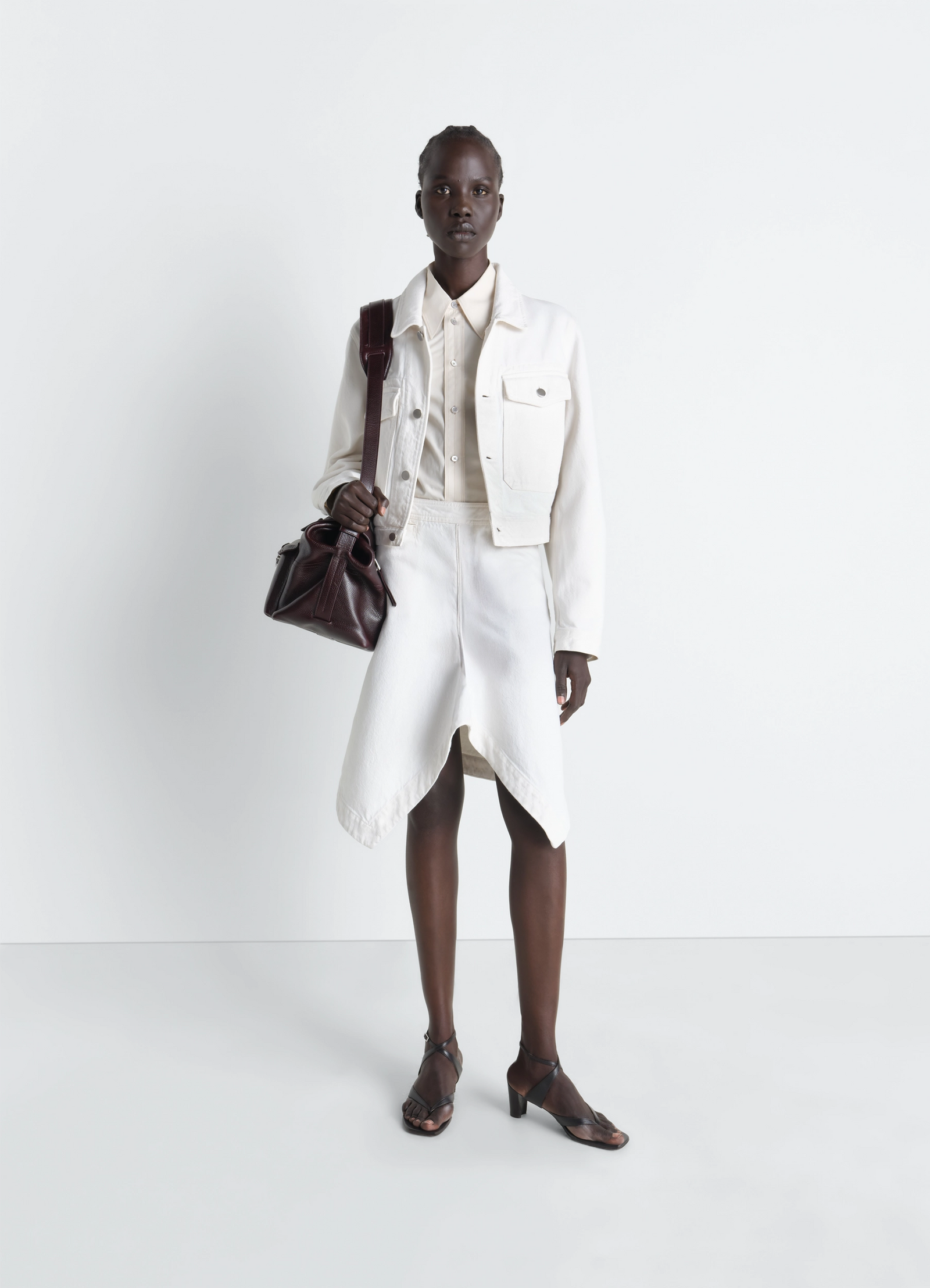 Cropped blouson in denim in bleached denim, model shot, 3/4 view button front closure