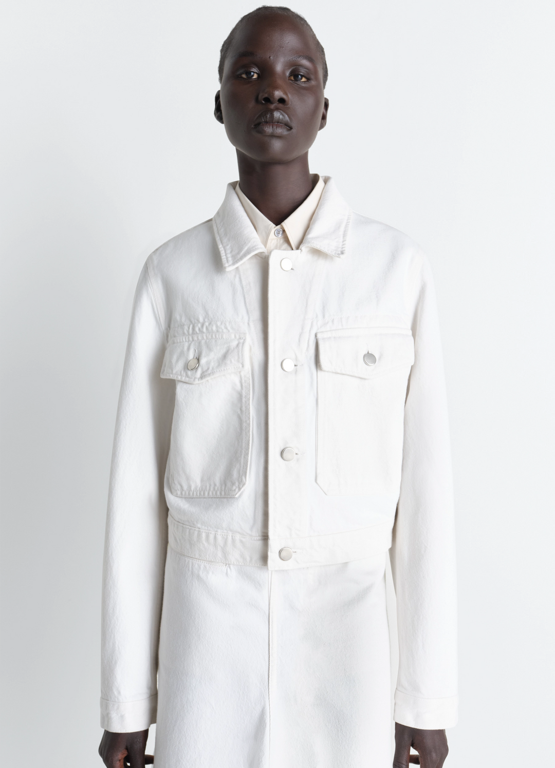 Cropped Blouson in Denim in Bleached Denim, model shot, Front view Cropped fit with pockets