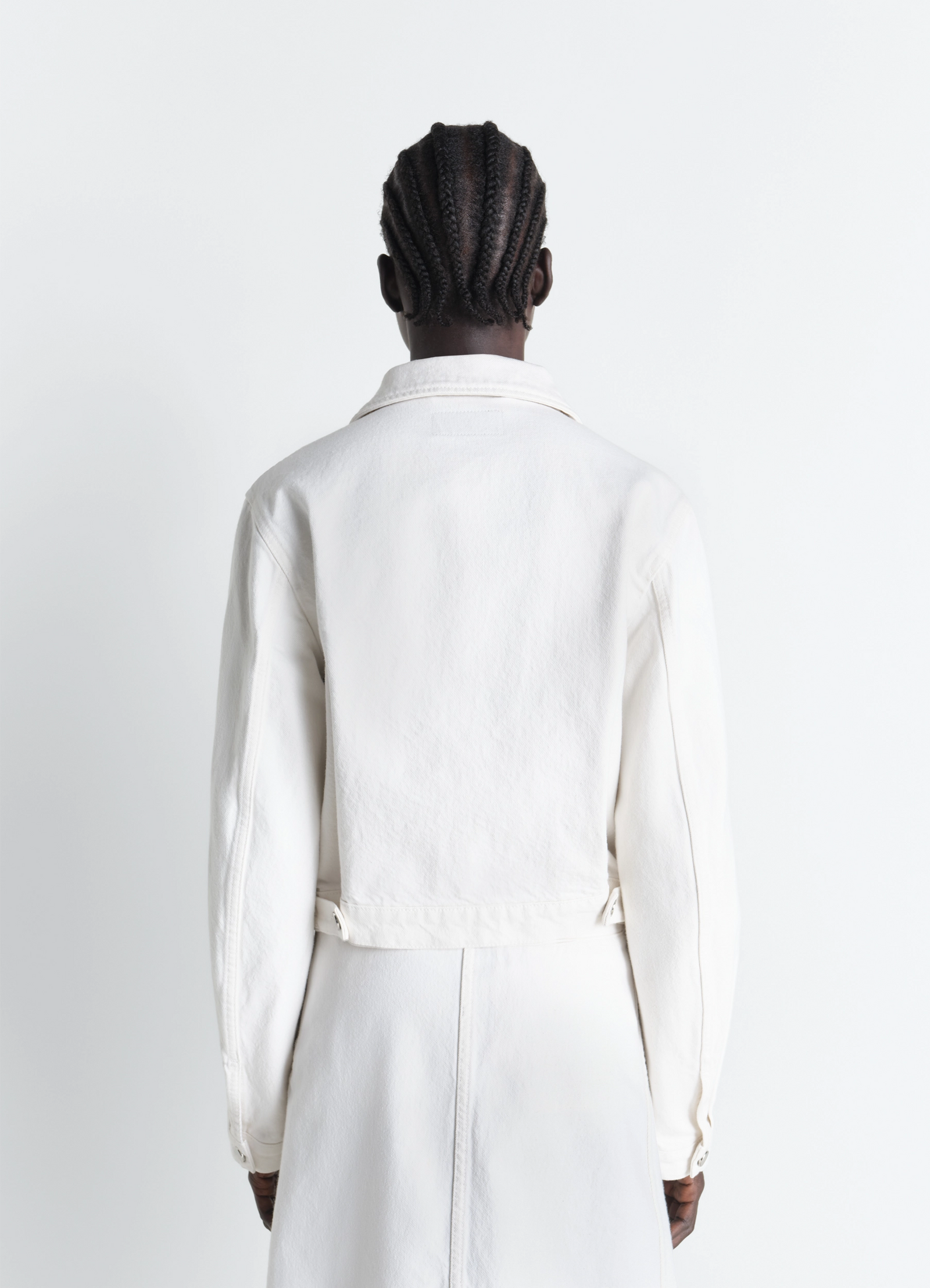 Cropped blouson in denim in bleached denim, model shot, back full view waist button tab detail