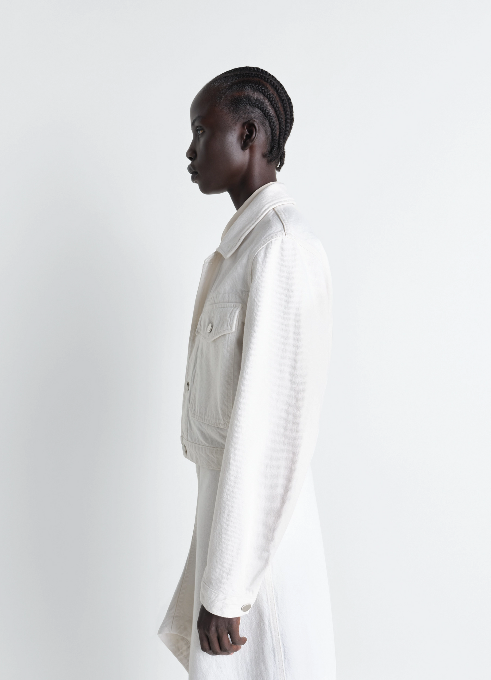 Cropped blouson in denim in bleached denim, model shot, side profile view fitted sleeve design