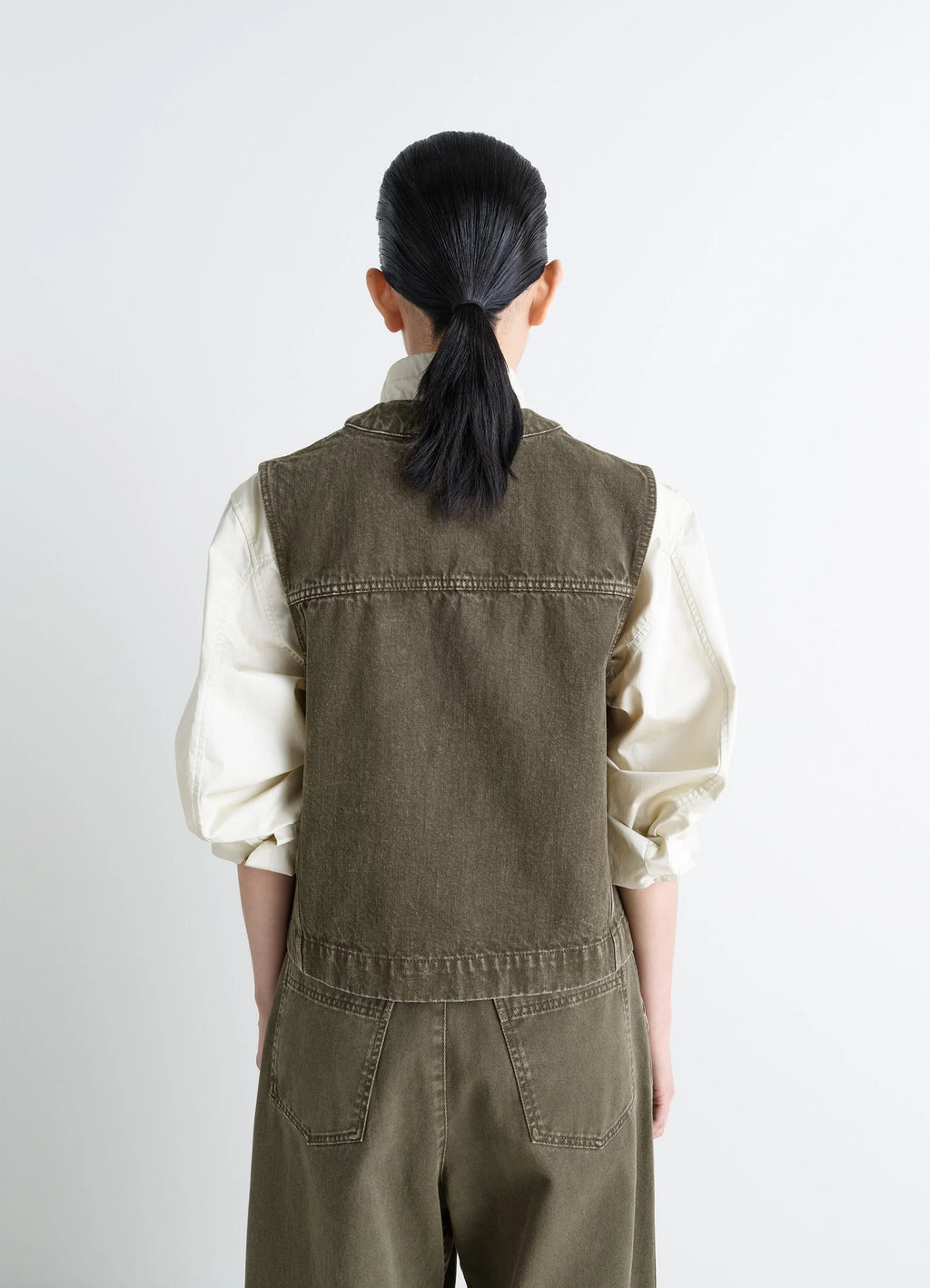 Lemaire Pocket Gilet in Garment Dyed Snow Thick Denim, model shot, back view straight cut