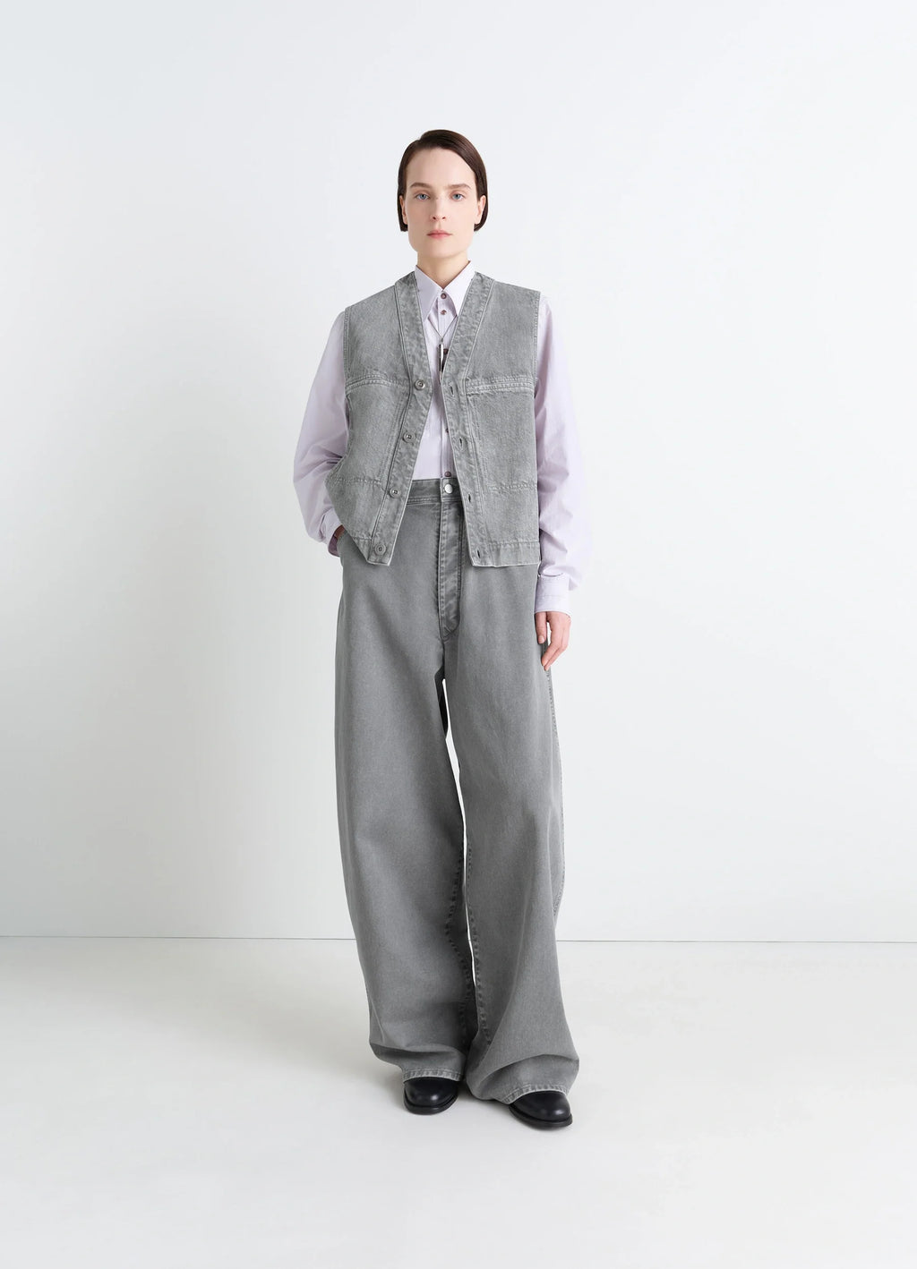 Lemaire Pocket Gilet in Garment Dyed Snow Denim, model shot, three-quarter view relaxed fit structure