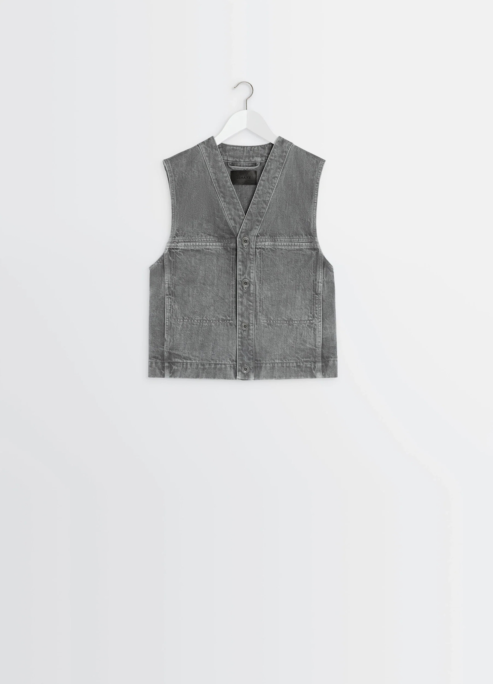 Lemaire pocket gilet in garment dyed snow denim, product shot, straight-on hanging view deep v-neck utilitarian cut