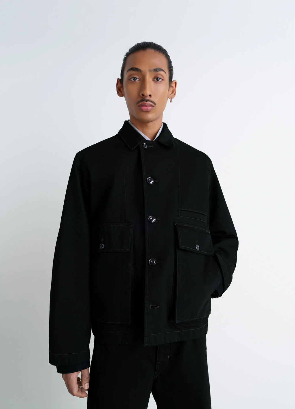 Lemaire Boxy Jacket in Heavy Black Denim, model shot, three-quarter view buttoned pockets visible