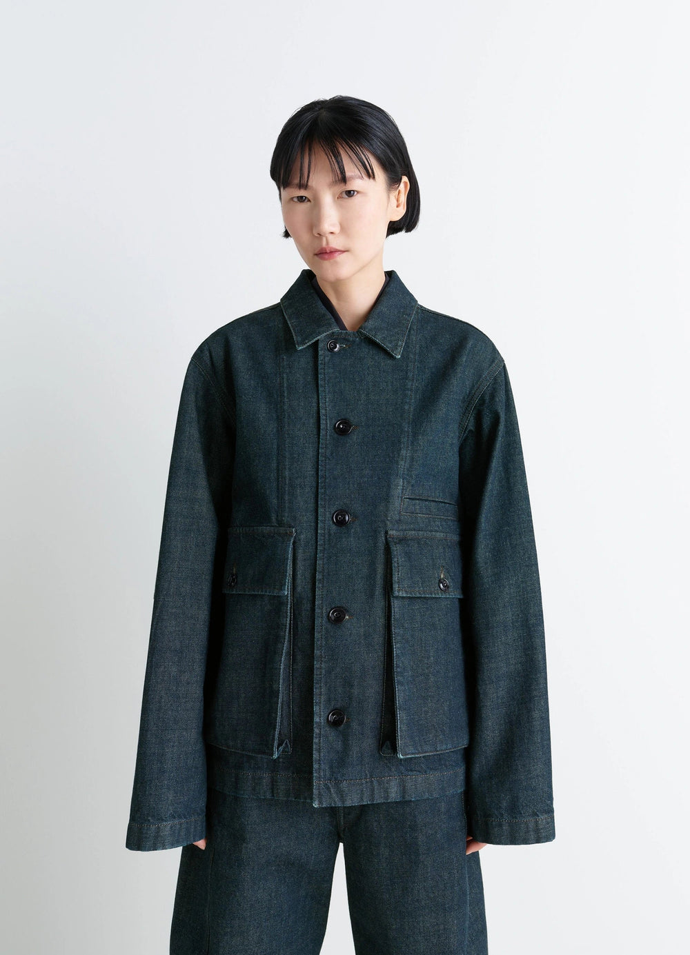 Lemaire Boxy Jacket in Deep Indigo Denim, model shot, close-up view buttoned long sleeves