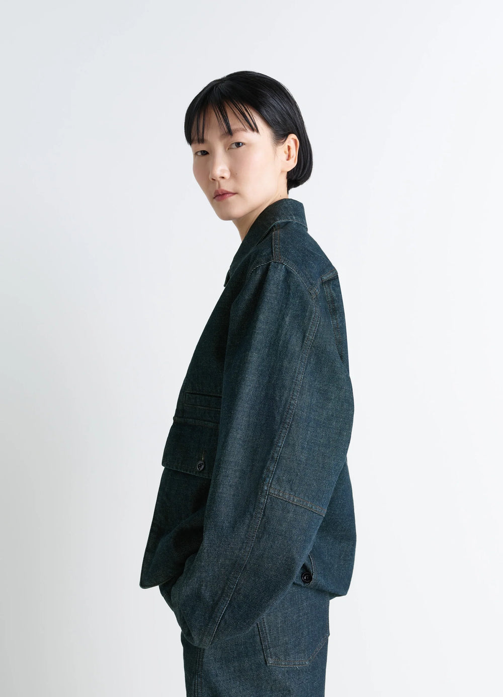 Lemaire Boxy Jacket in Deep Indigo Denim, model shot, side view dropped shoulder seam