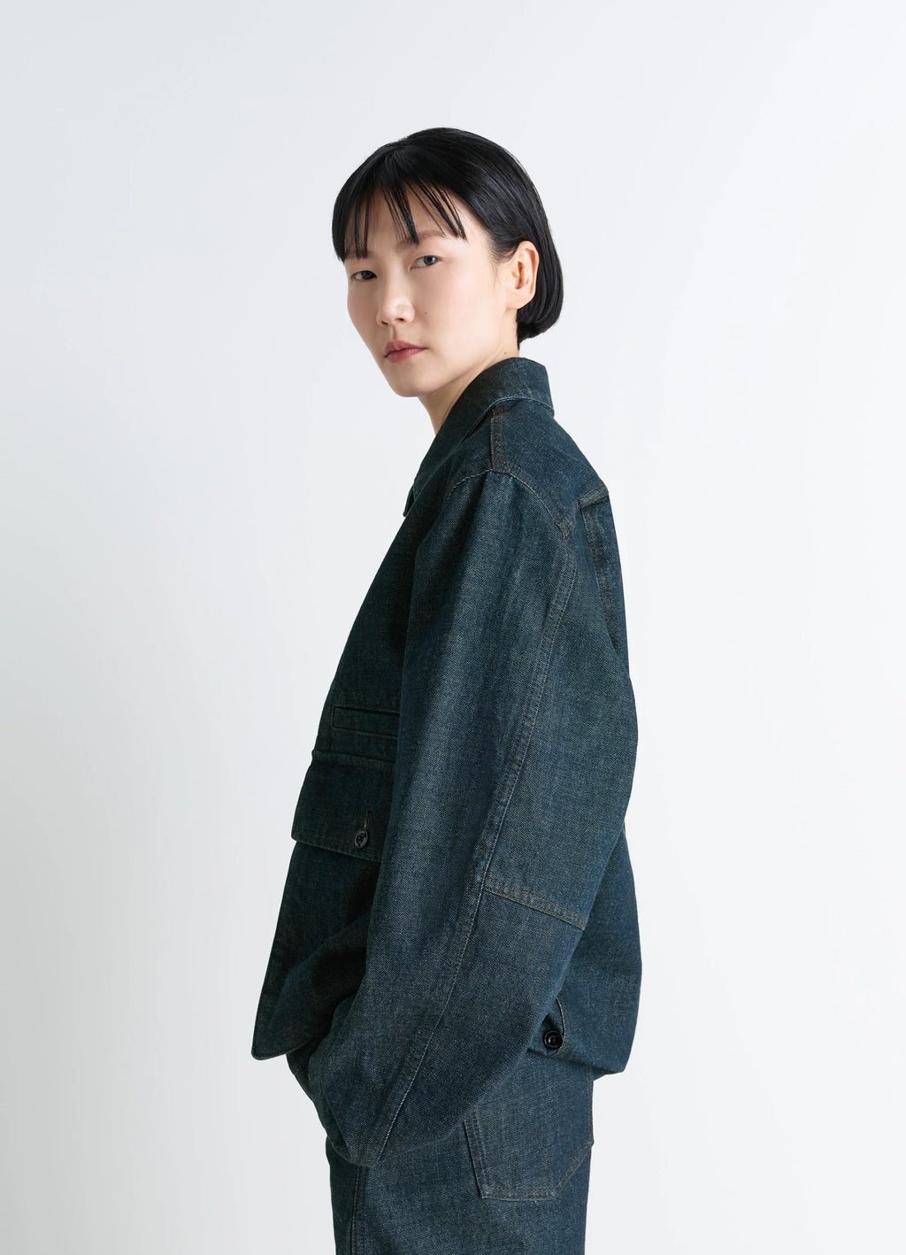 Lemaire Boxy Jacket in Deep Indigo Denim, model shot, side view dropped shoulder seam