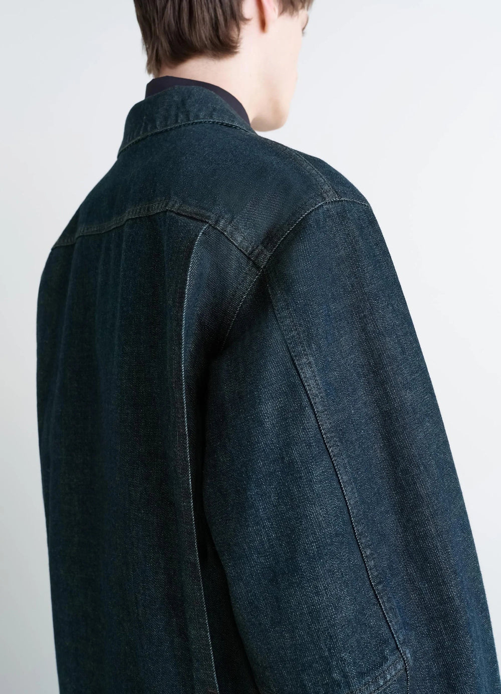 Lemaire Boxy Jacket in Deep Indigo Denim, model shot, back shoulder view stitched back yoke seam