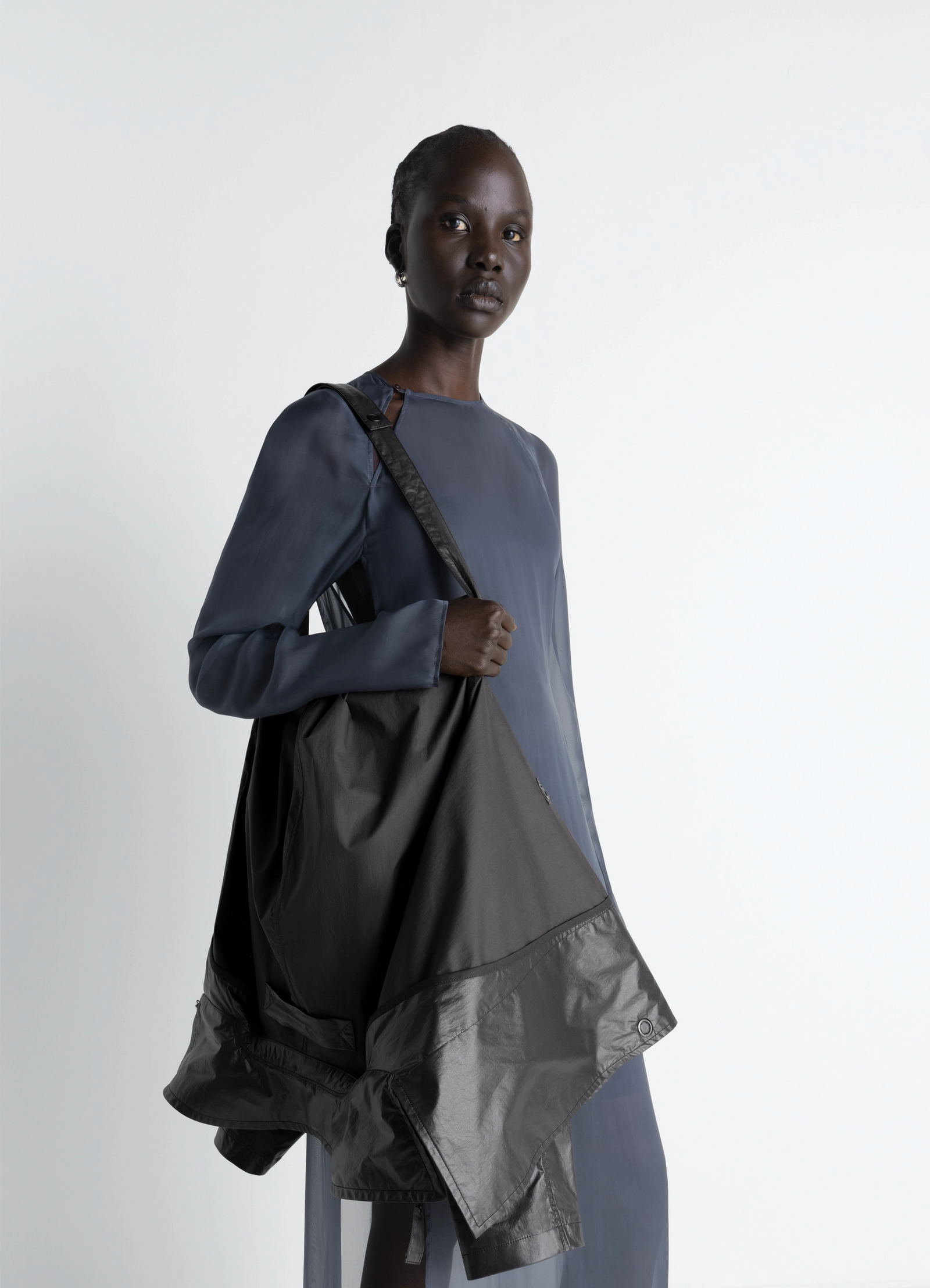 Light wrap jacket in light coated cotton, model shot, over shoulder view asymmetrical hem detail