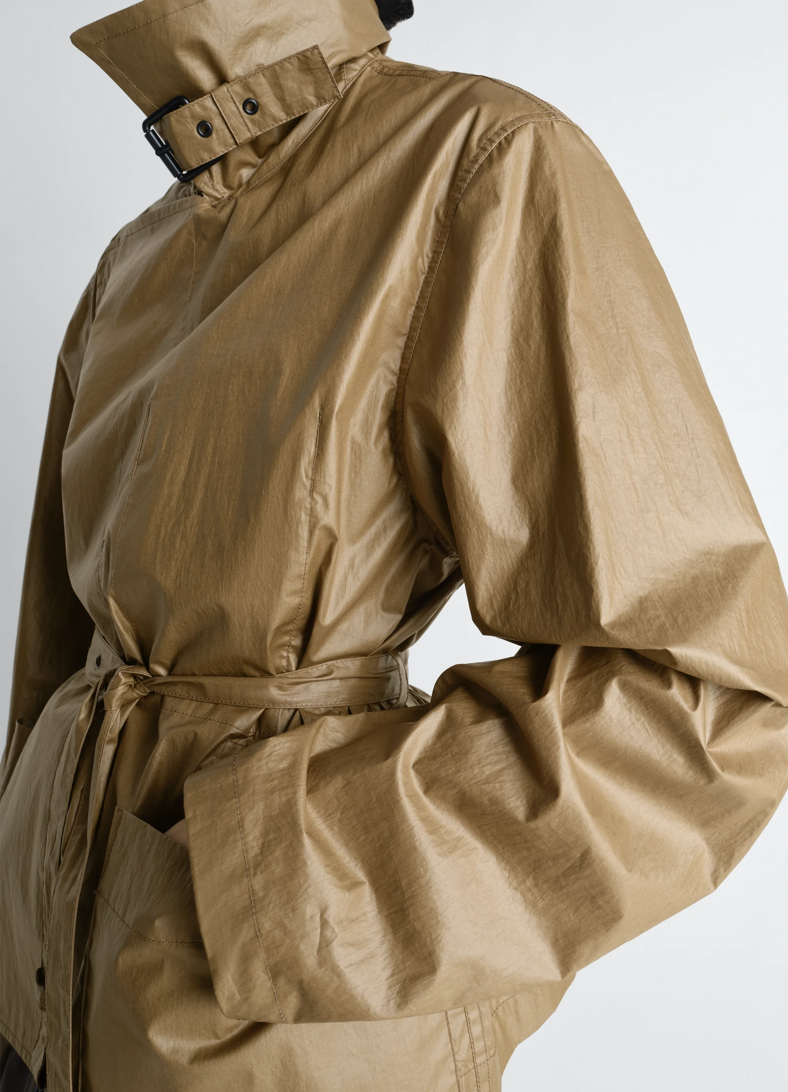 Light wrap jacket in light coated cotton, model shot, close-up waist view soft texture, long sleeves