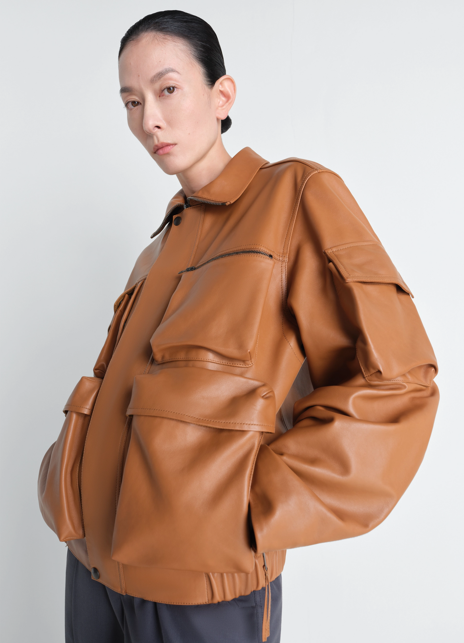 Lemaire leather blouson in cowhide leather, model shot, side profile view draped sleeve detail
