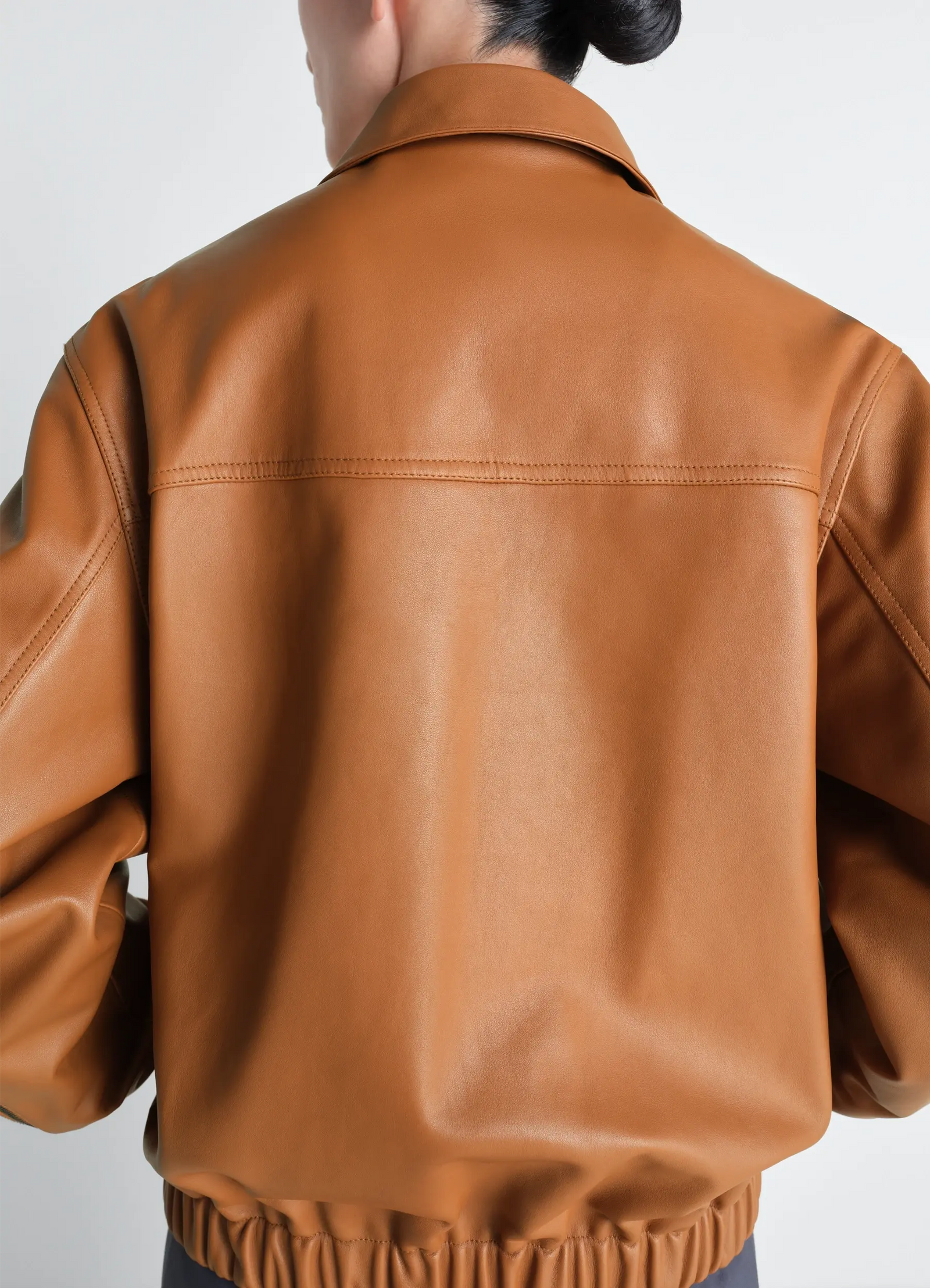 Lemaire leather blouson in cowhide leather, model shot, back view elastic hem detail