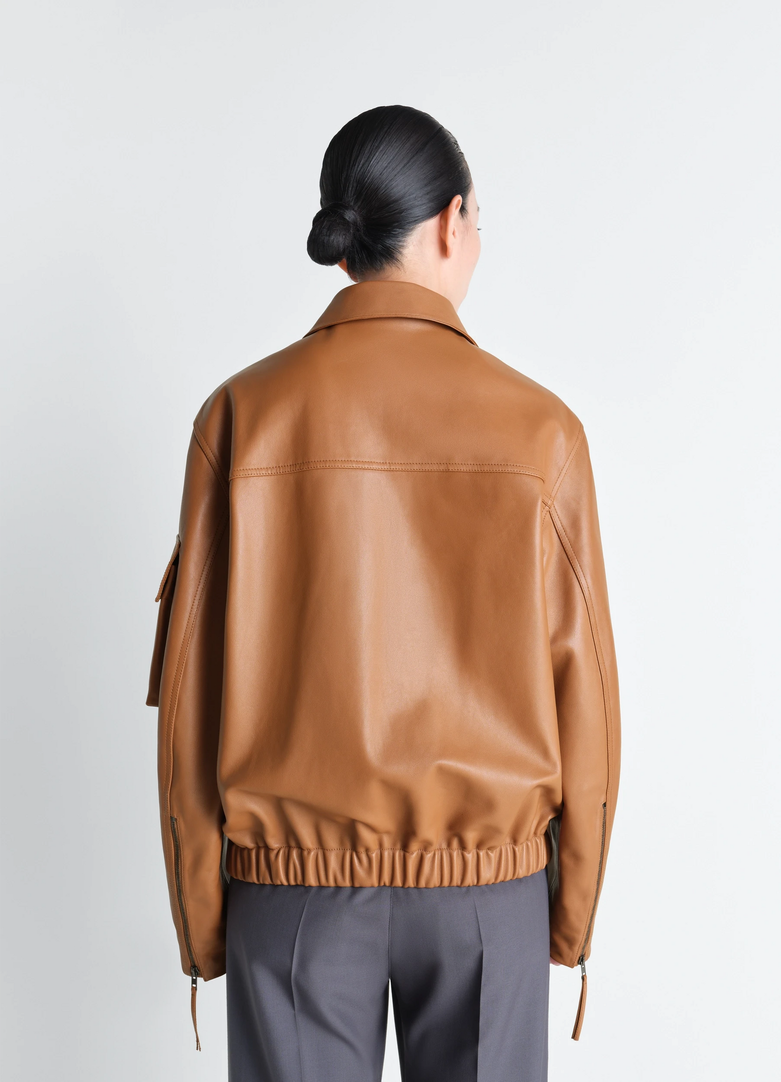 Lemaire leather blouson in cowhide leather, model shot, rear upper body view elastic waistline detail