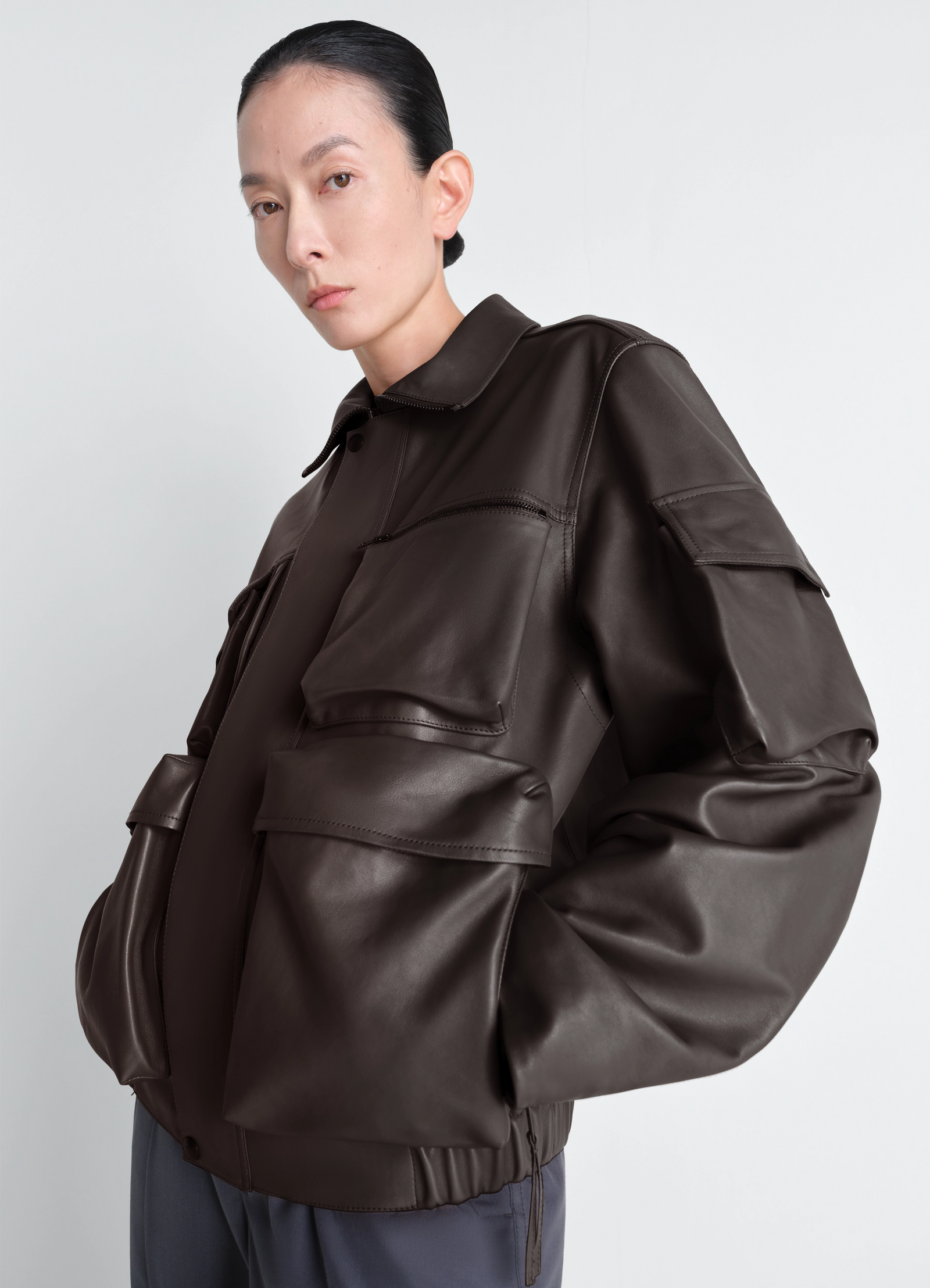 Lemaire leather blouson in cowhide leather, model shot, two-thirds side view slouchy fit, oversized sleeves