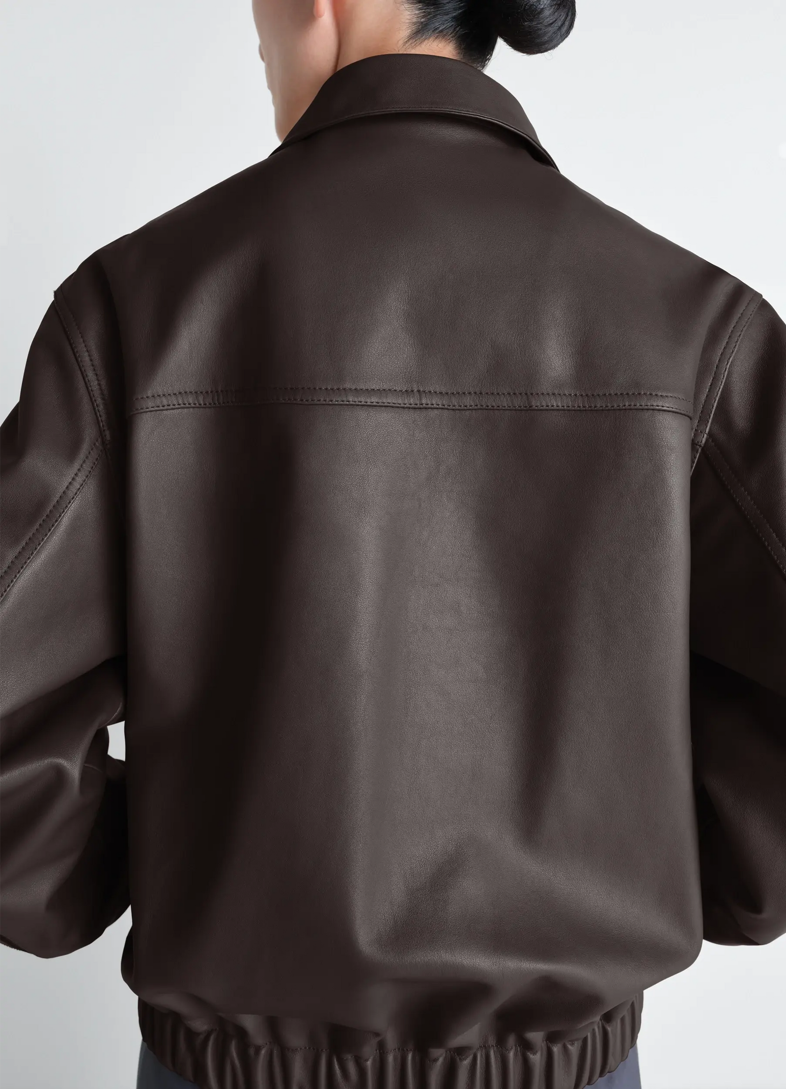 Lemaire leather blouson in cowhide leather, model shot, back view elasticated hem
