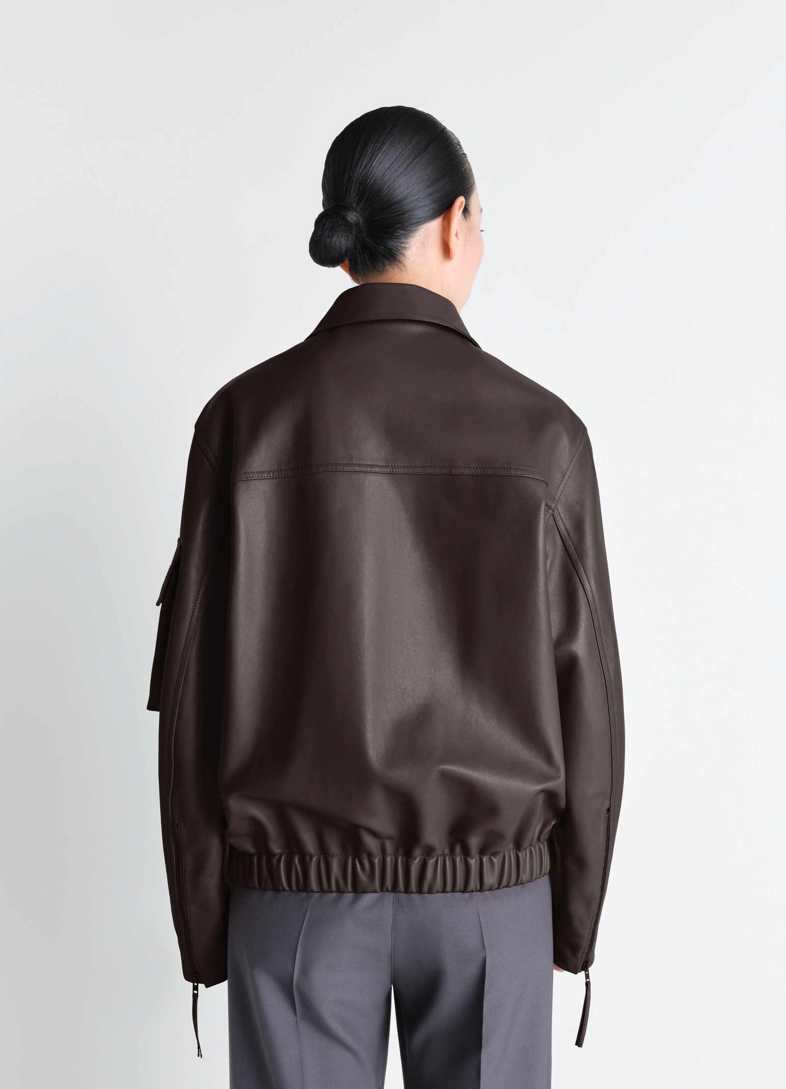 Lemaire leather blouson in cowhide leather, model shot, back detail view gathered elastic hem