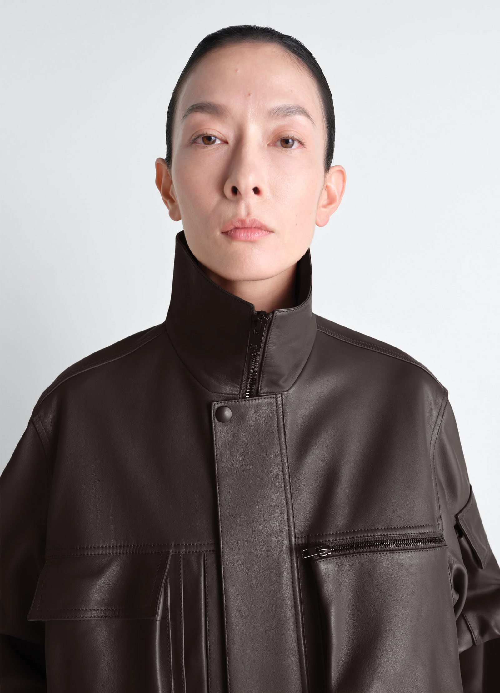 Lemaire leather blouson in cowhide leather, model shot, close-up view zipper detail, buttoned collar