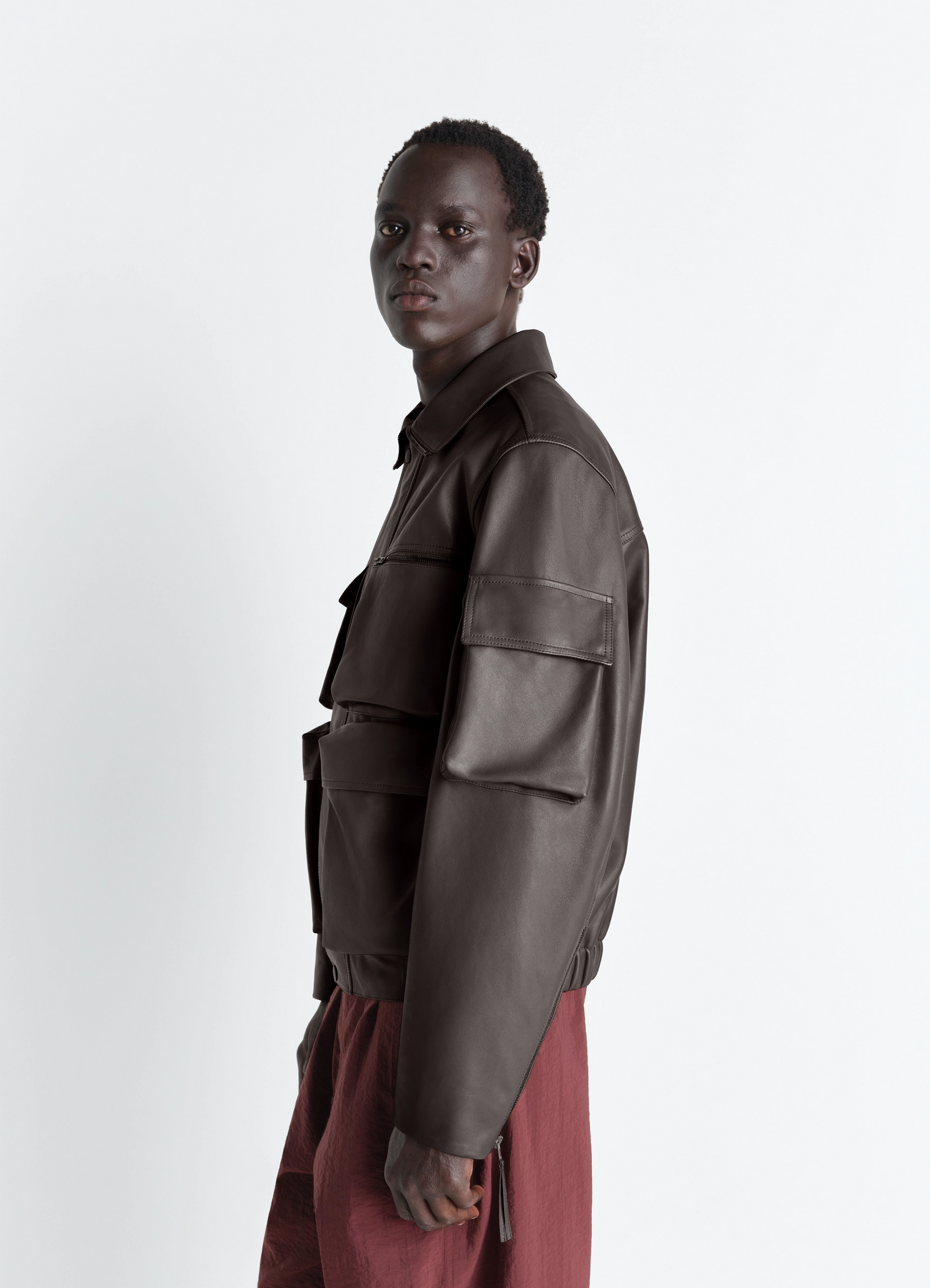 Lemaire leather blouson in cowhide leather, model shot, over-shoulder side view cropped fit, sleeve zipper