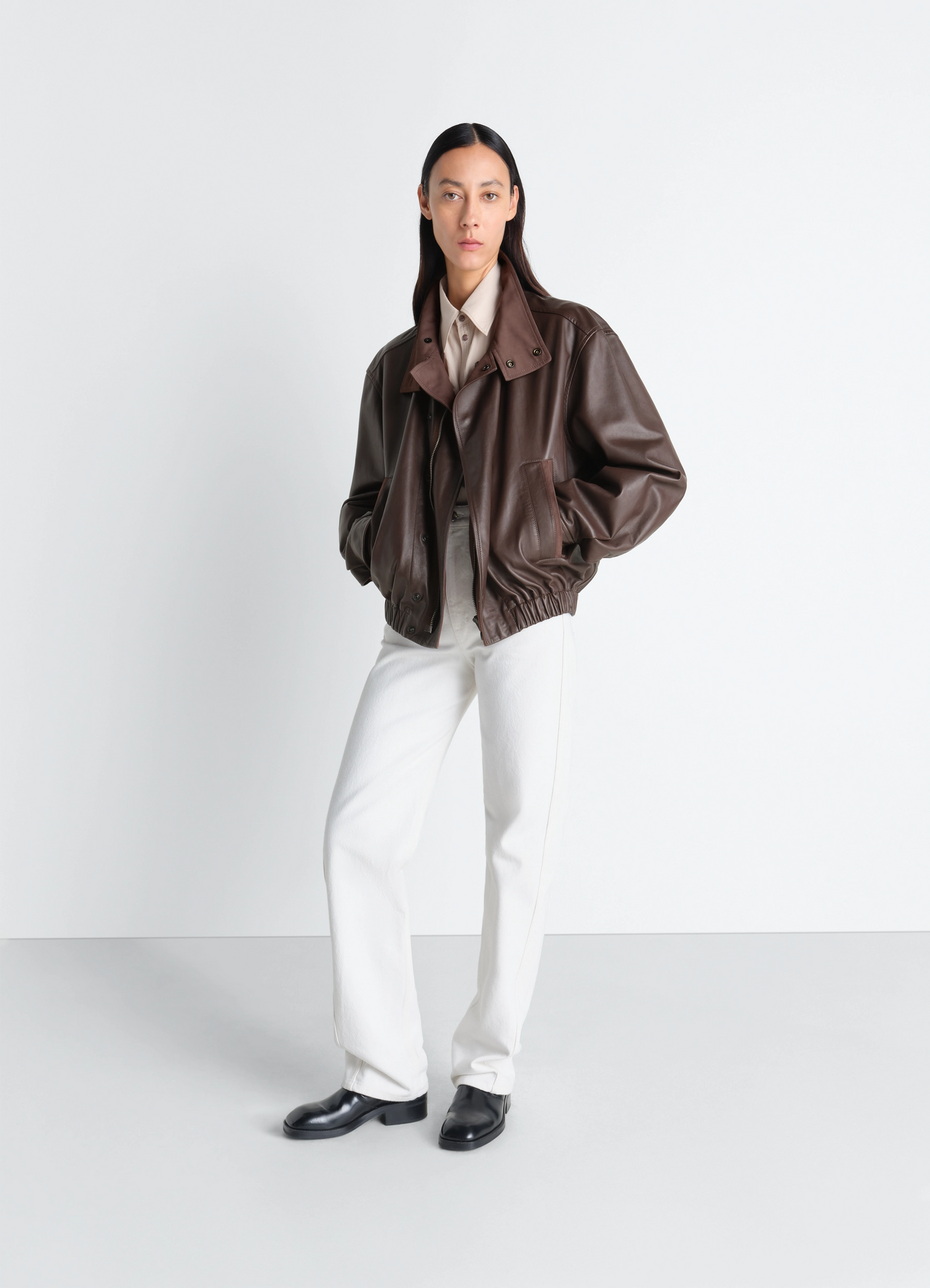 Lemaire soft leather blouson in paper leather, model shot, three-quarter view elastic hem detail