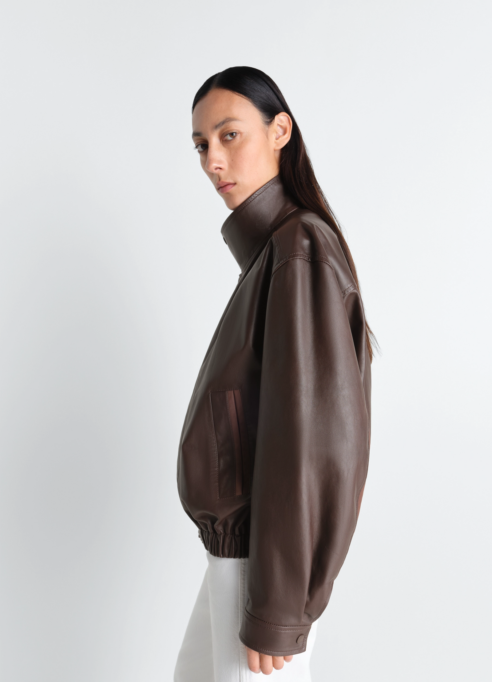 Lemaire soft leather blouson in paper leather, model shot, three-quarter side view elastic hem, high collar